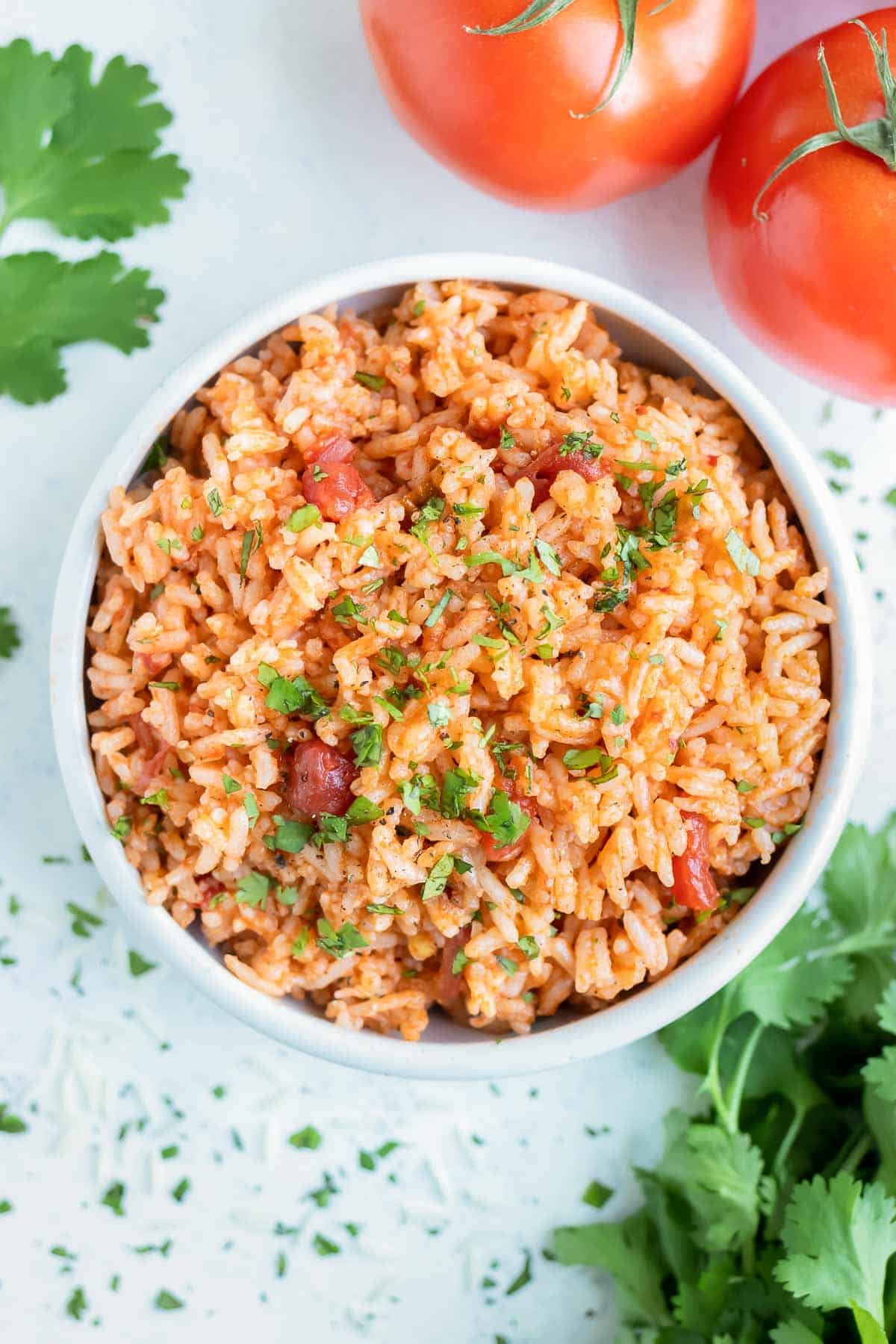 A white bowl is used to hold the instant pot Mexican rice.