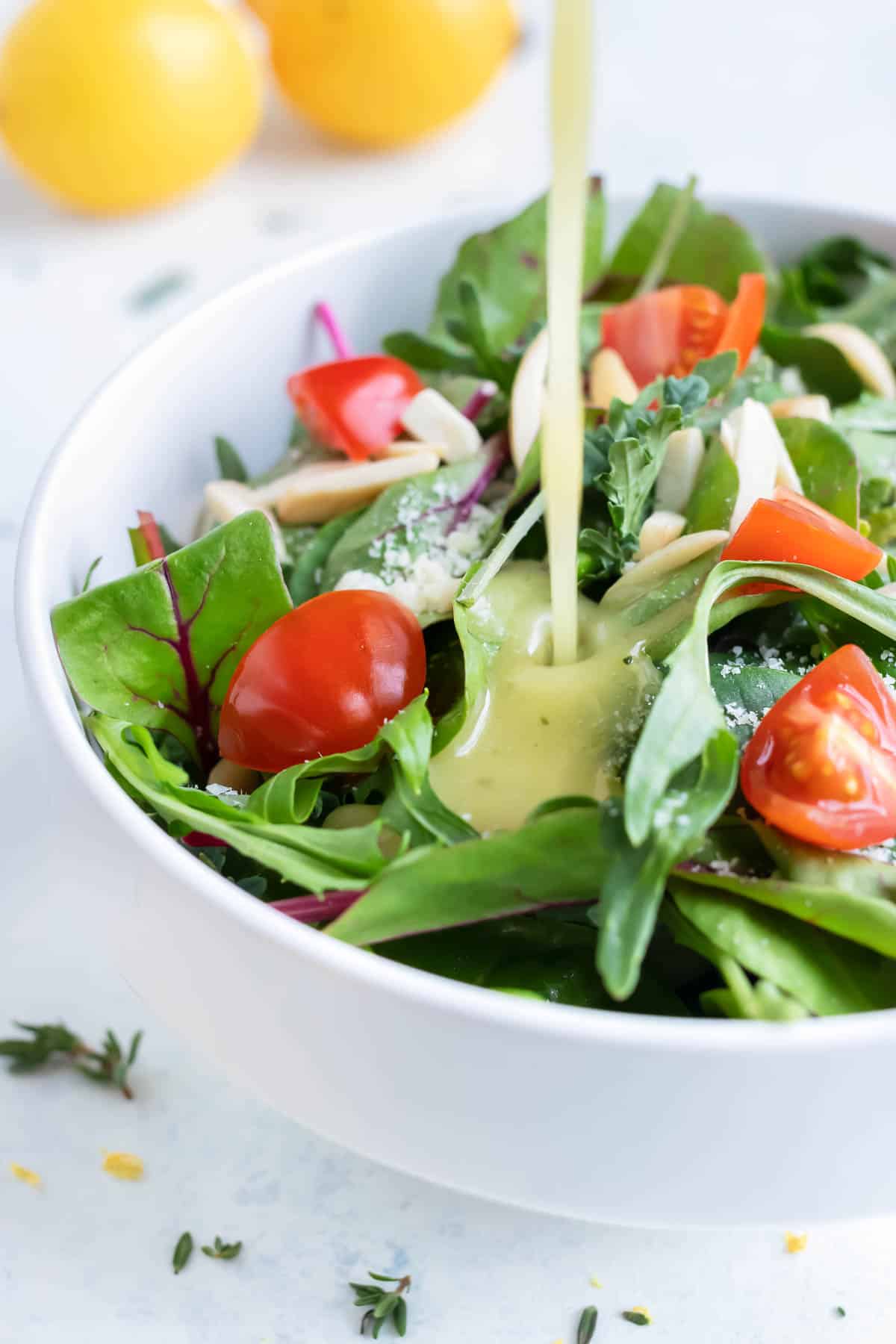 Lemon Vinaigrette is drizzled onto a healthy green salad.