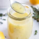 Easy homemade vinaigrette is served with a metal spoon.