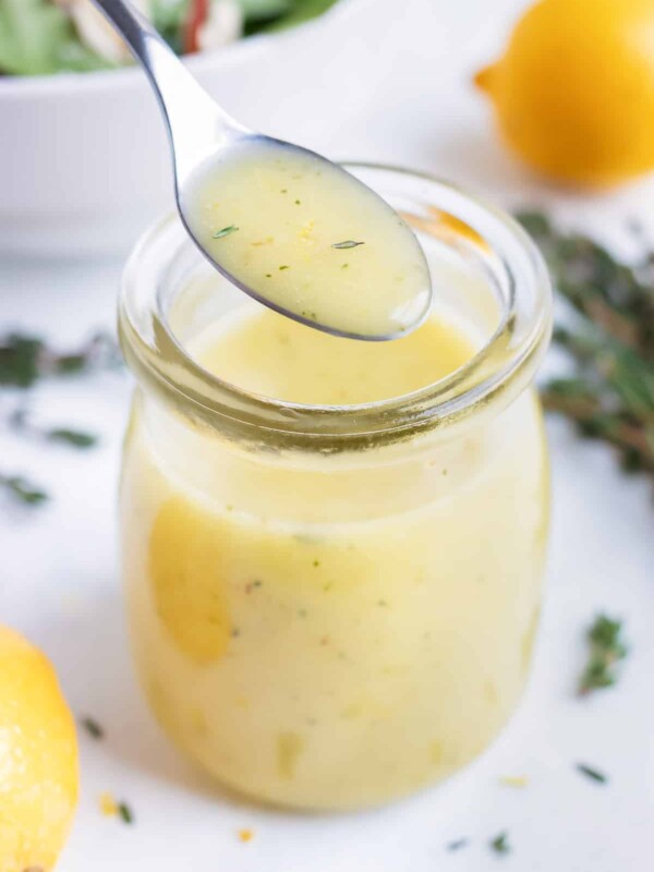 Easy homemade vinaigrette is served with a metal spoon.