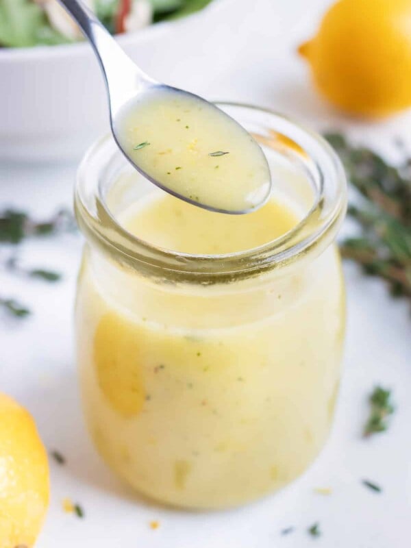 Easy homemade vinaigrette is served with a metal spoon.