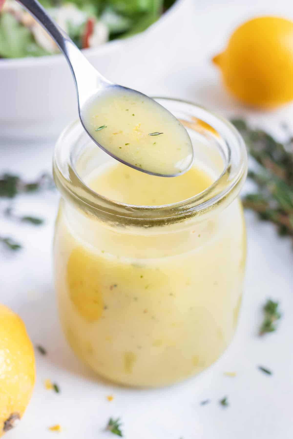 Easy homemade vinaigrette is served with a metal spoon.