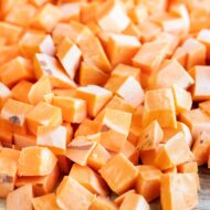 Sweet potatoes are peeled and chopped into cubes.