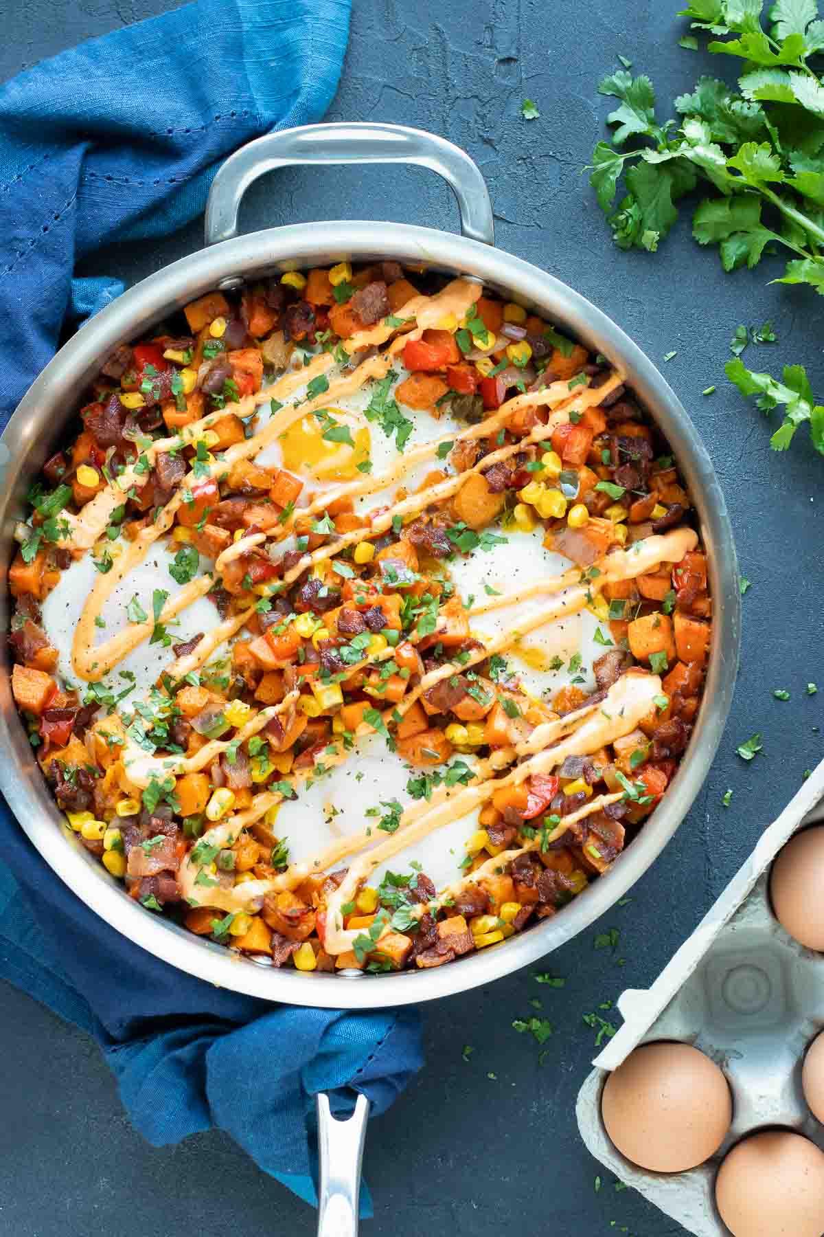 Learn how to make sweet potato hash with eggs in a stainless steel skillet.
