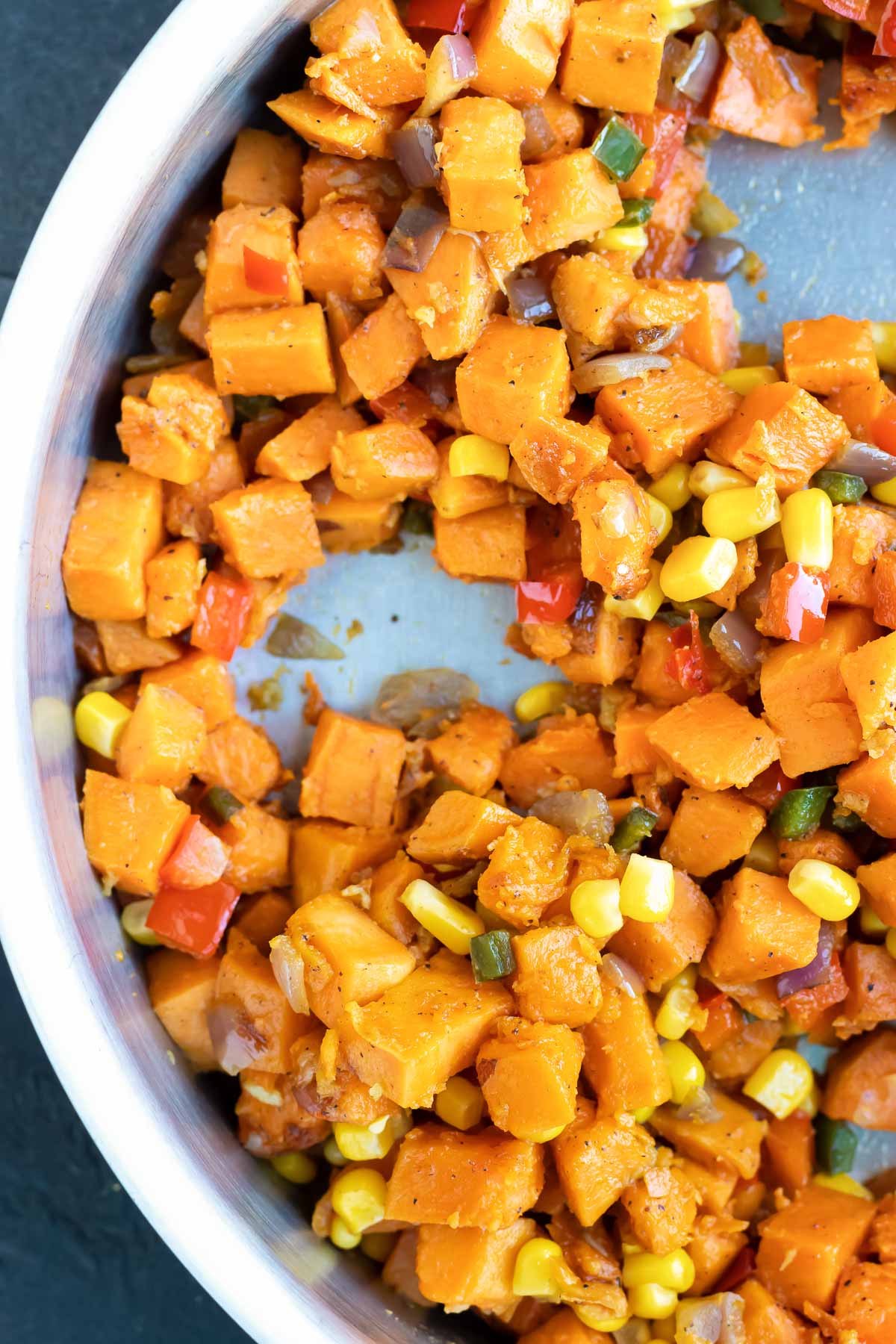 Sweet potatoes are added to the pan.