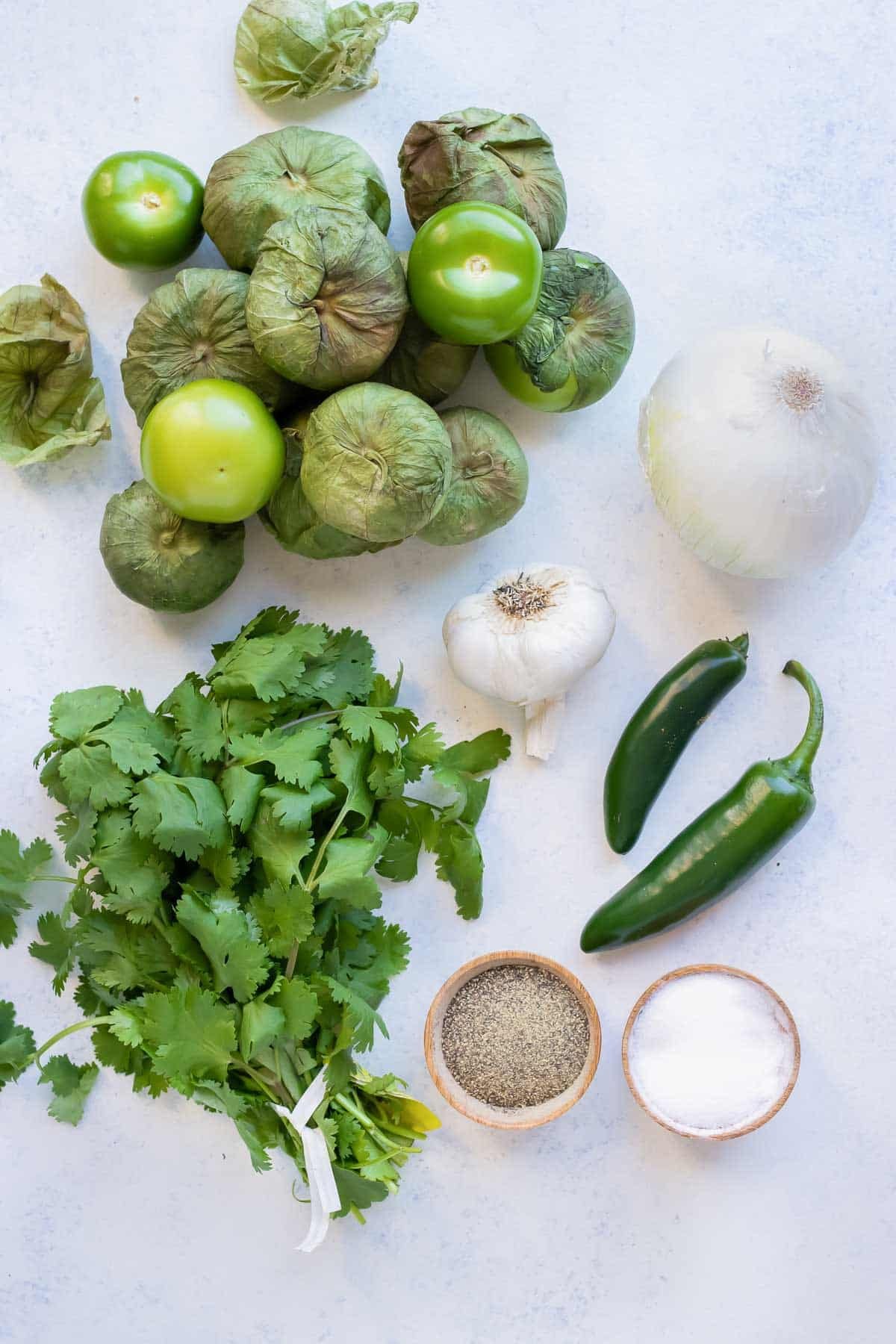 Tomatillos, cilantro, onion, garlic, jalapeño peppers, salt, and pepper are the ingredients for this recipe.
