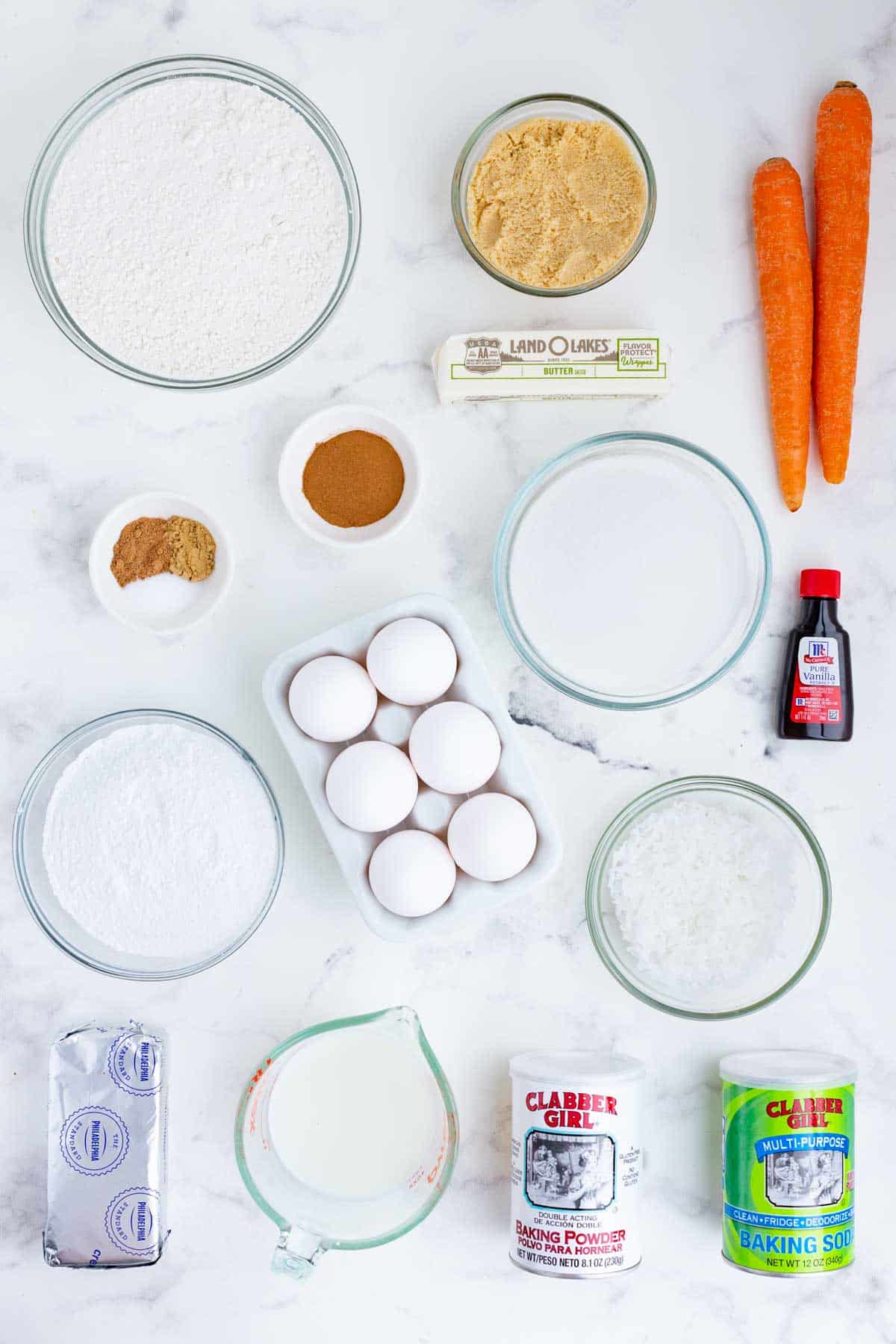 Carrots, coconut, flour, spices, butter, cream cheese, eggs, and sugar are the main ingredients for this dish.