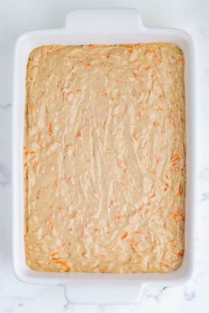 The batter is spread into a 9x13 baking dish.
