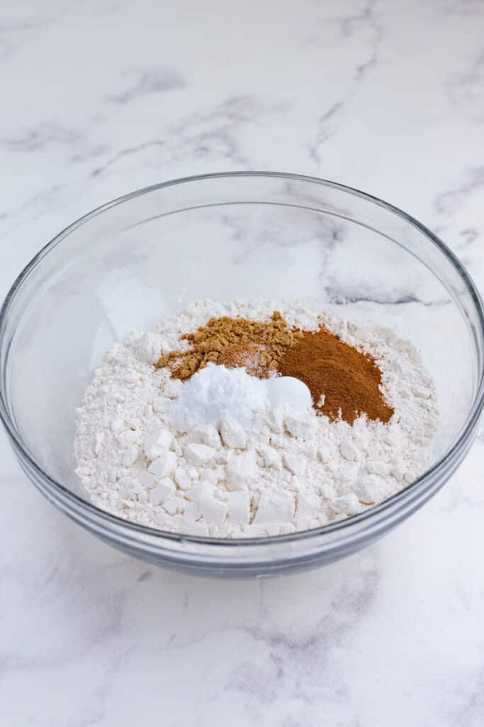 Dry ingredients are added to a bowl.