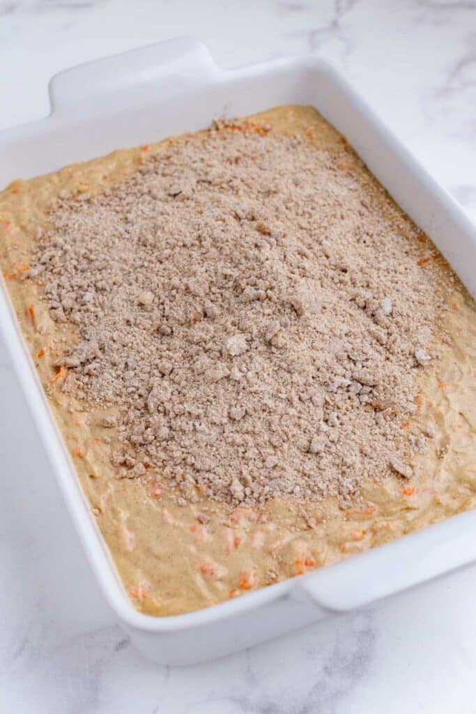 The crumb topping is spread across the batter.