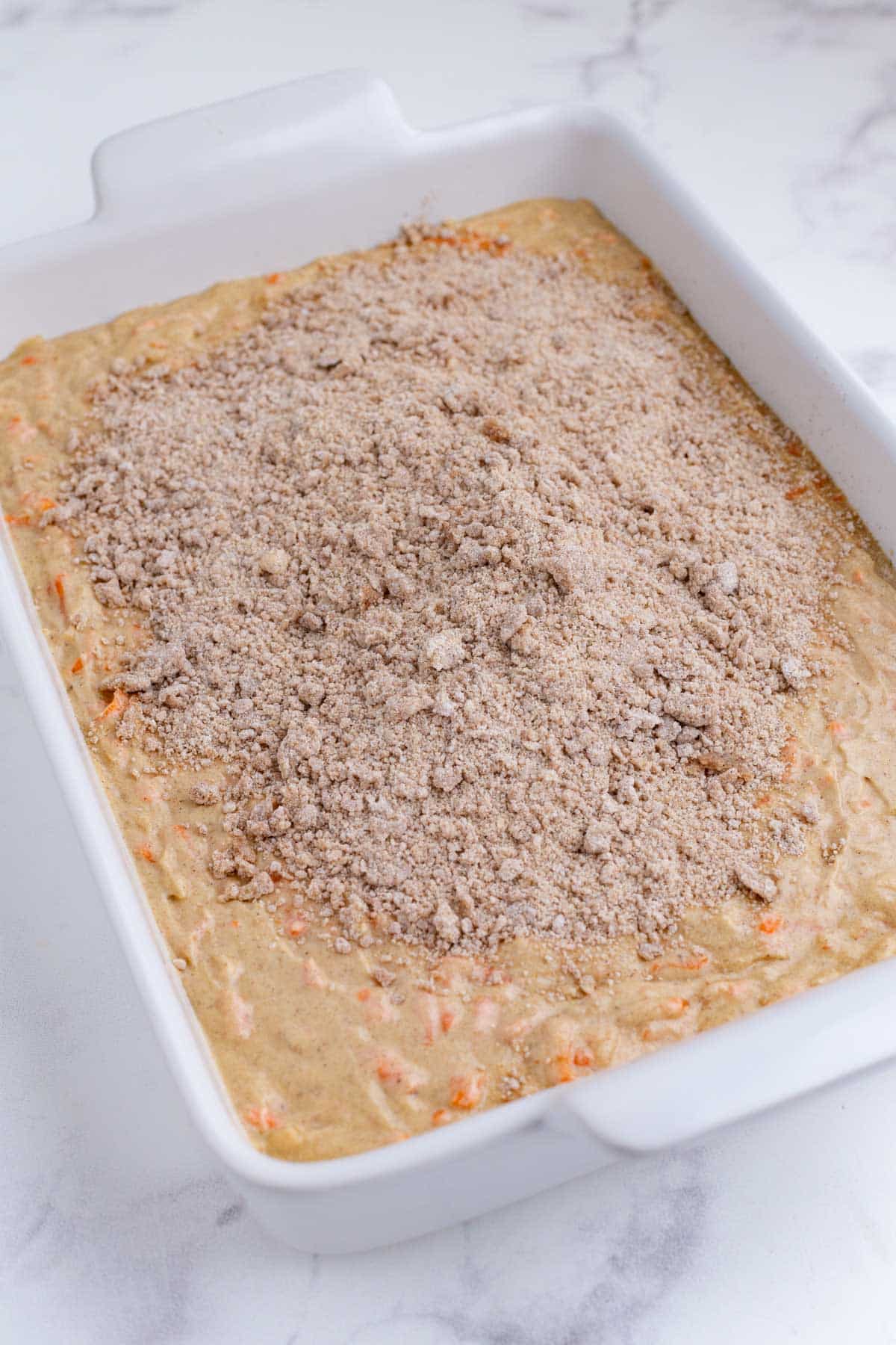 The crumb topping is spread across the batter.