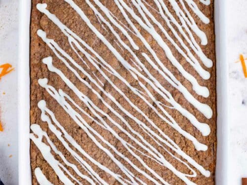 The cream cheese glaze is drizzled across the baked cake.