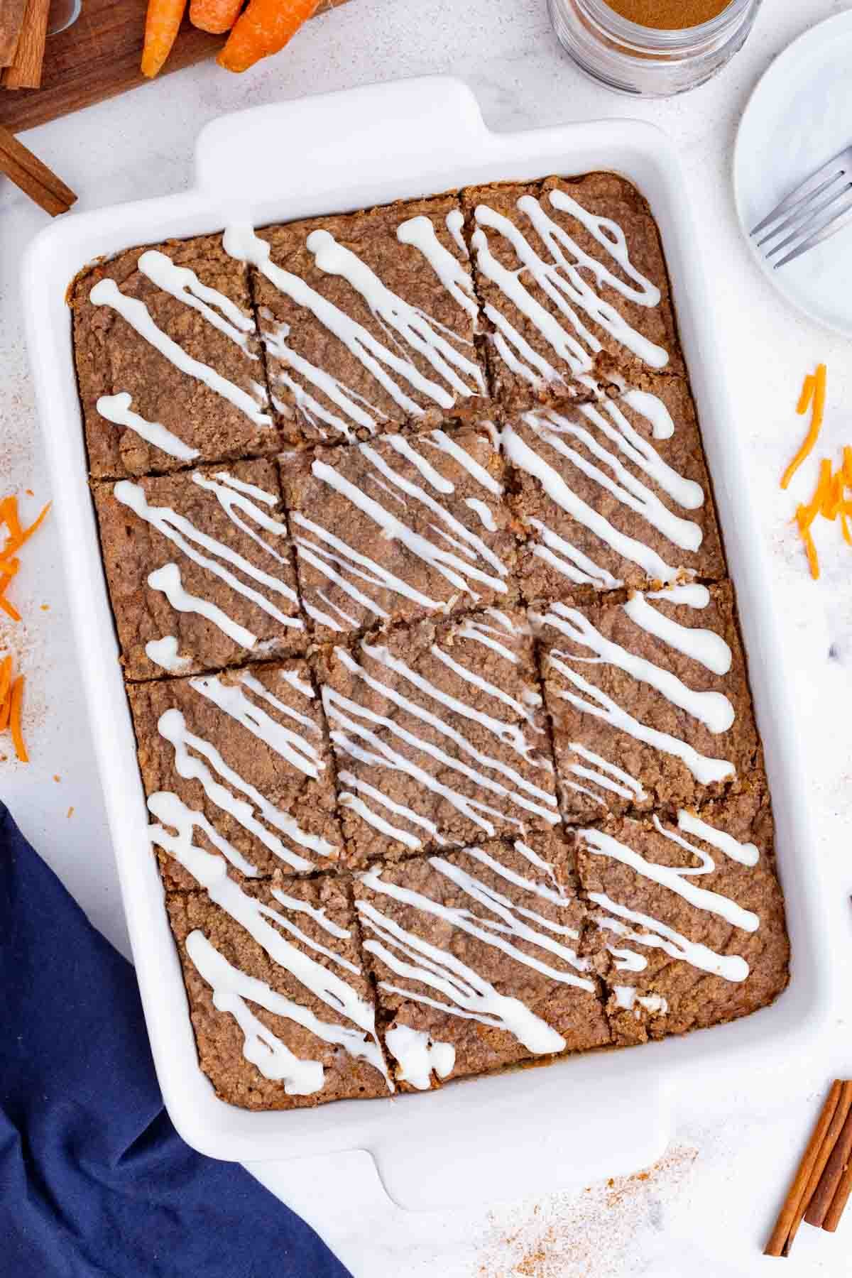 After drizzling the glaze, the cake is cut into squares.