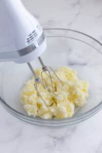 A mixer beats the butter and sugar.