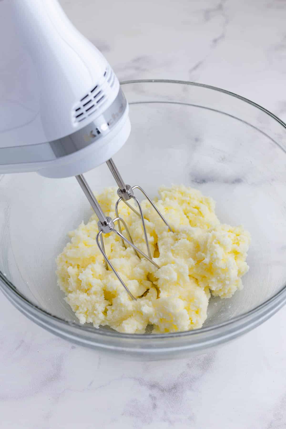 A mixer beats the butter and sugar.