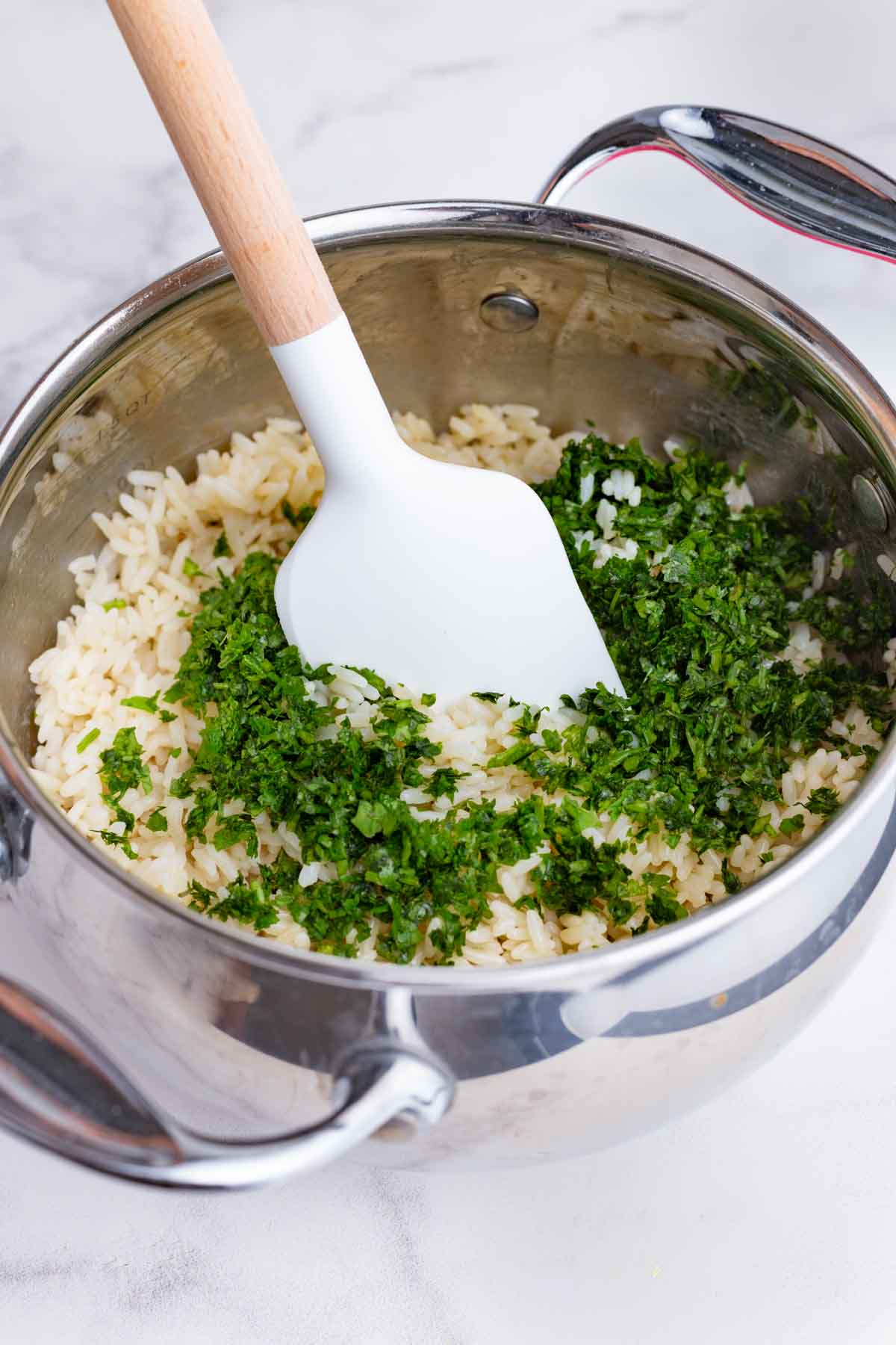 Cilantro lime rice is made in a pot on the stove.