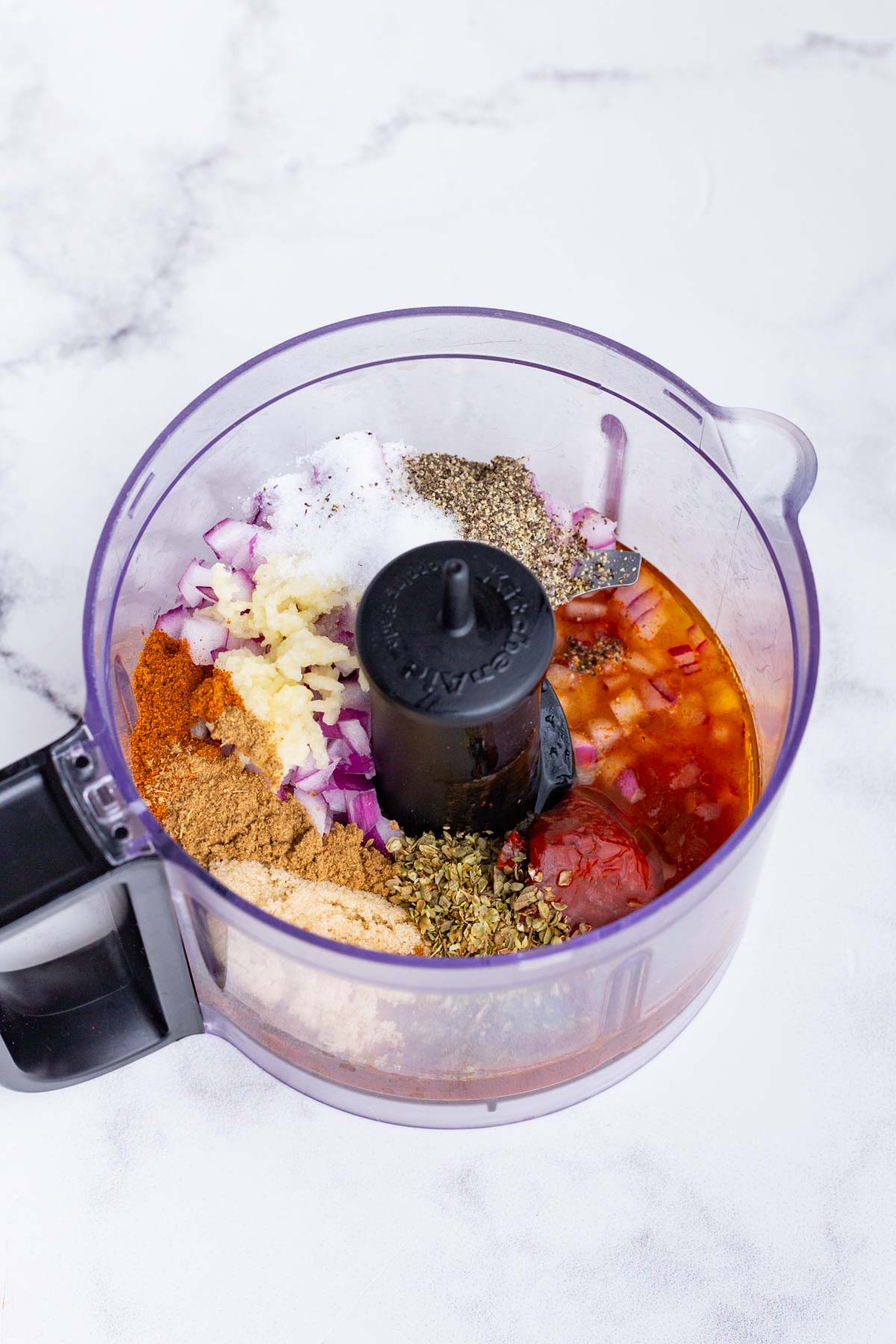 Marinade ingredients are placed in a food processor.