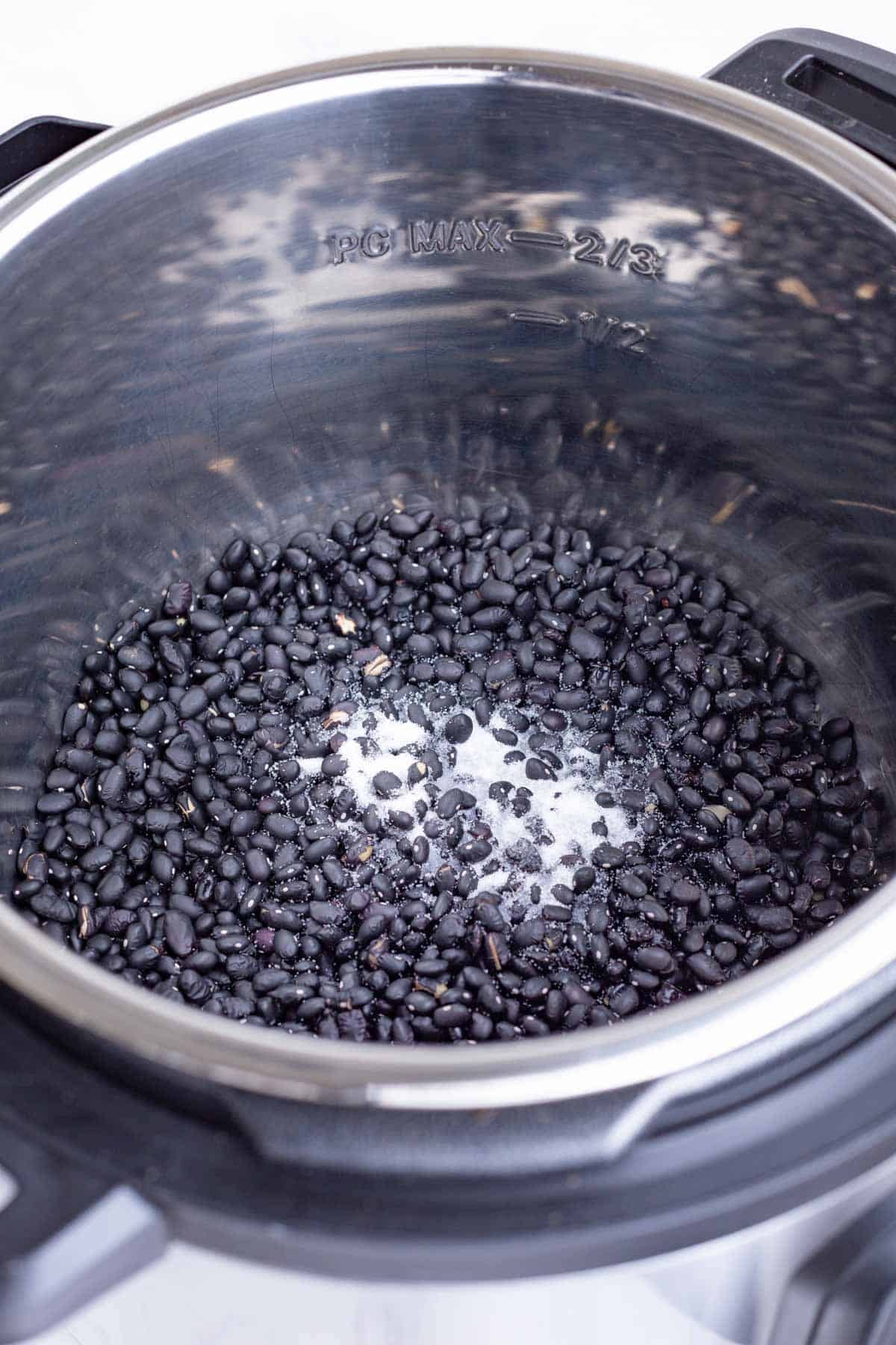 Salt is added to the black beans.