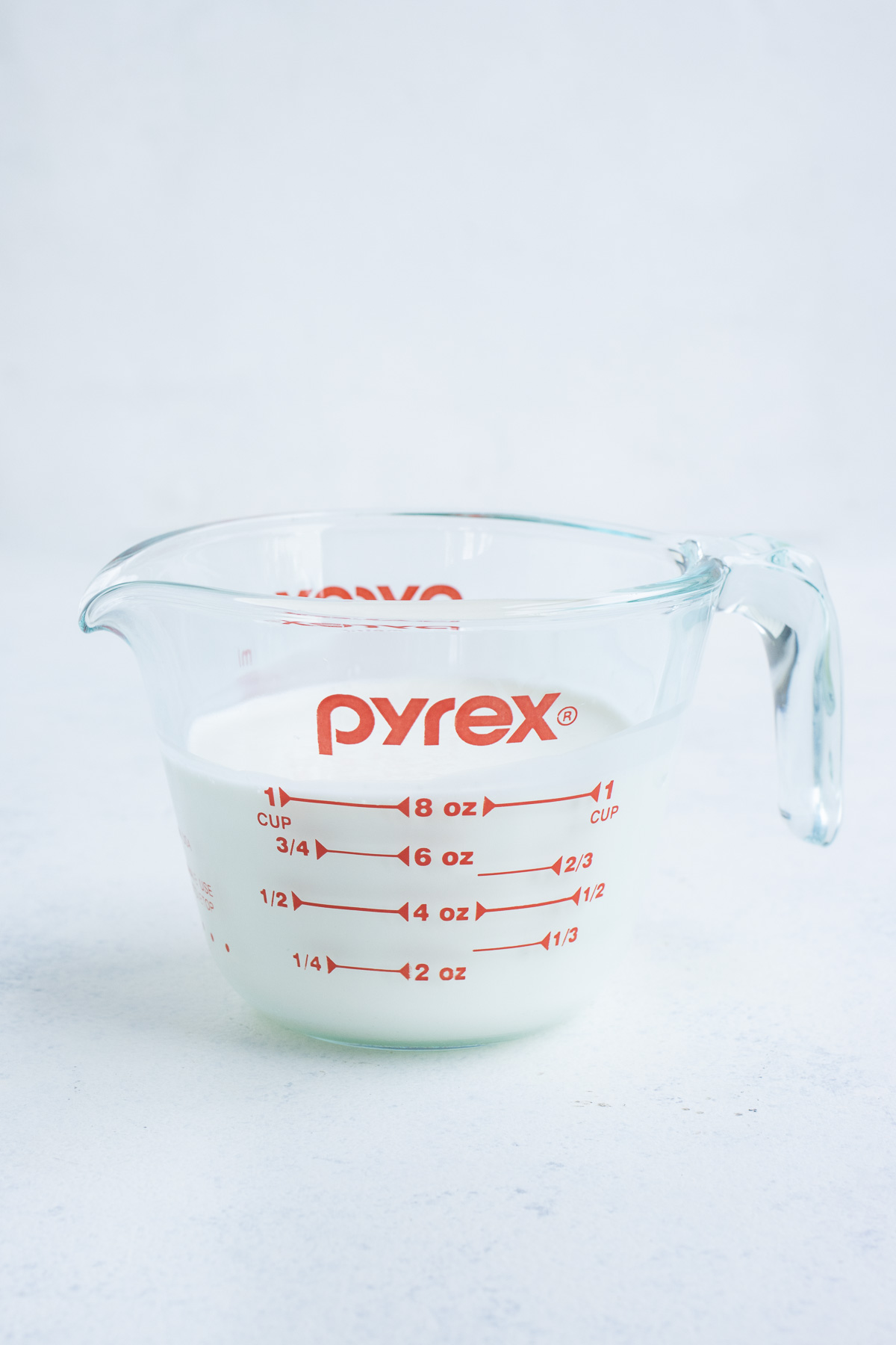 Milk in a glass measuring cup.