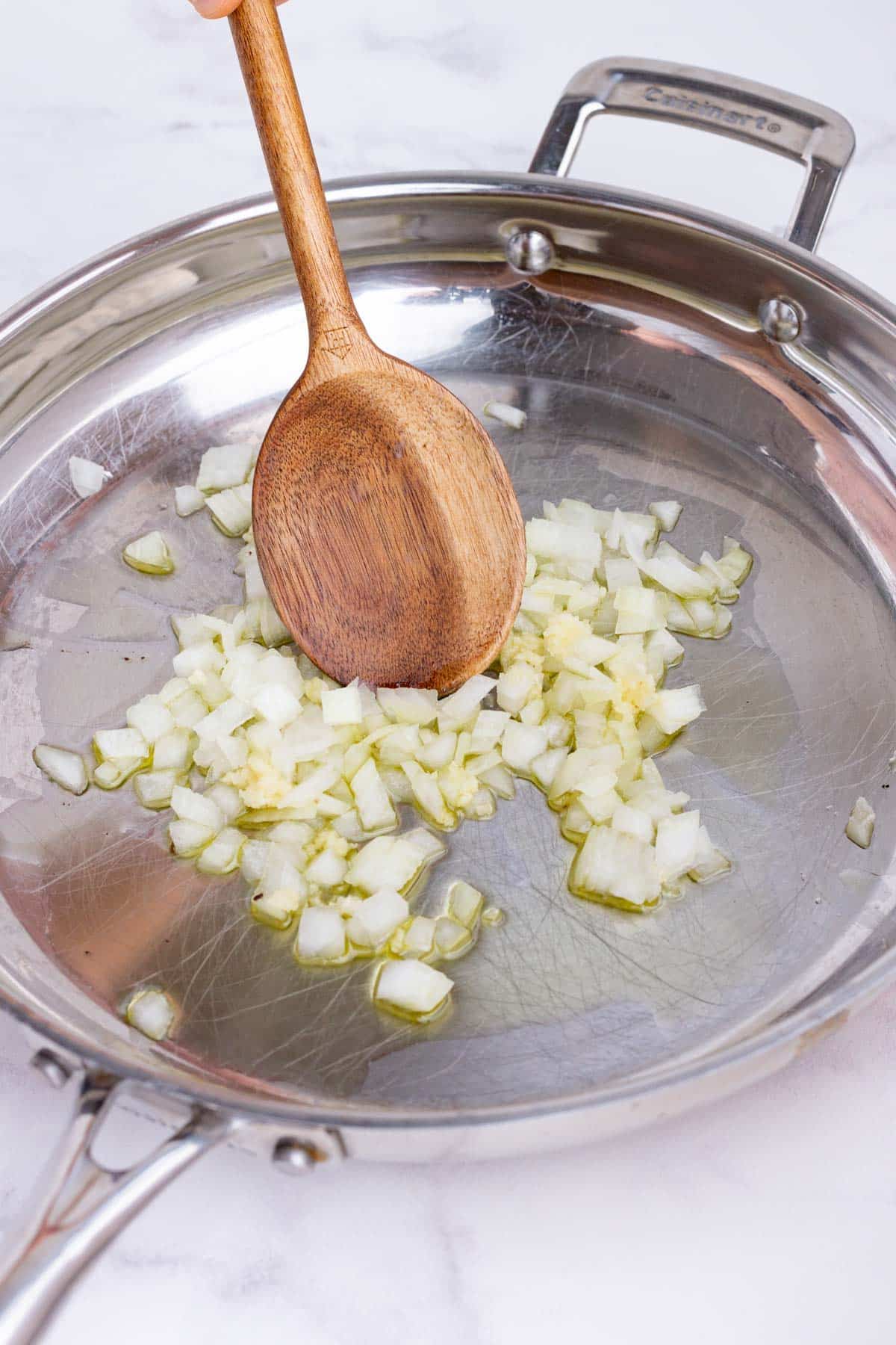 Garlic is added to the onion in the skillet.