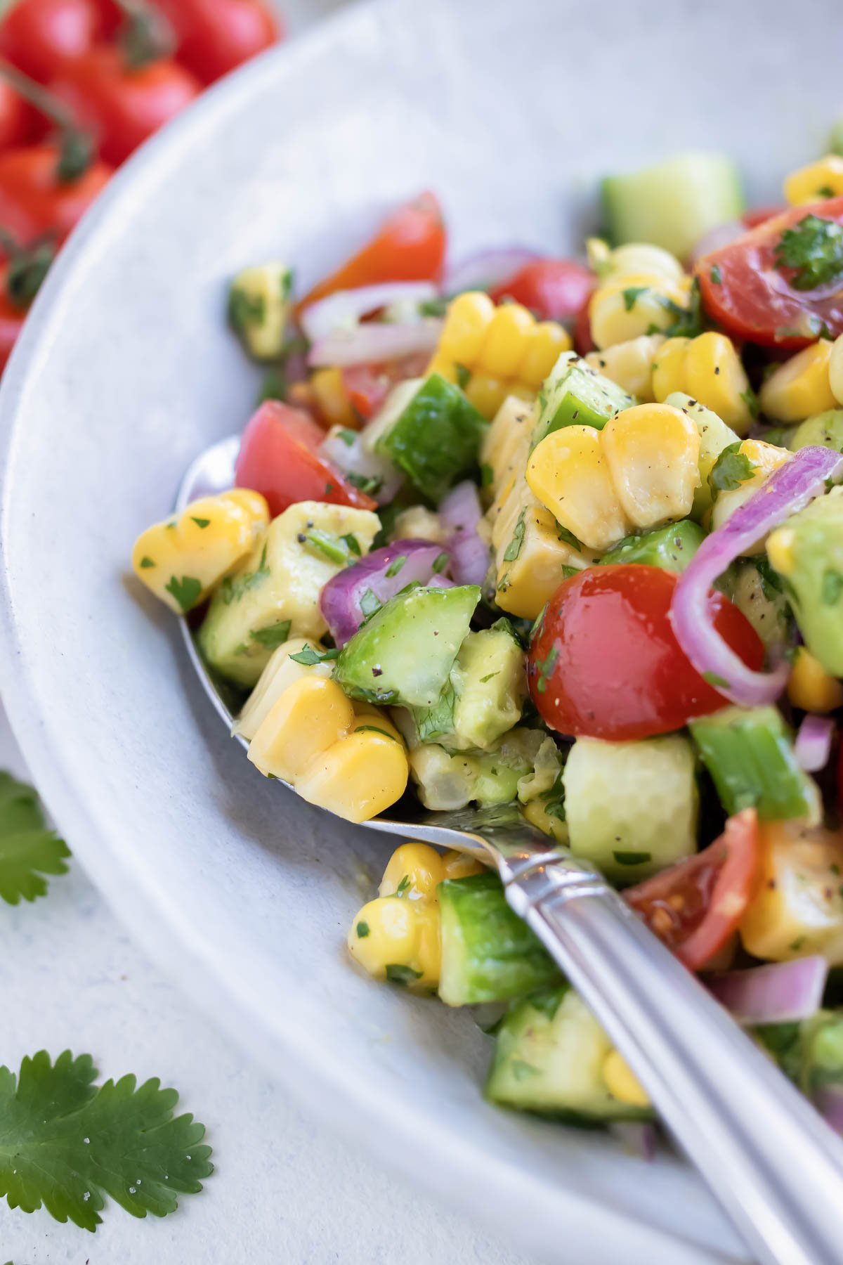 Avocado corn salad is served from a bowl for a light and refreshing side.