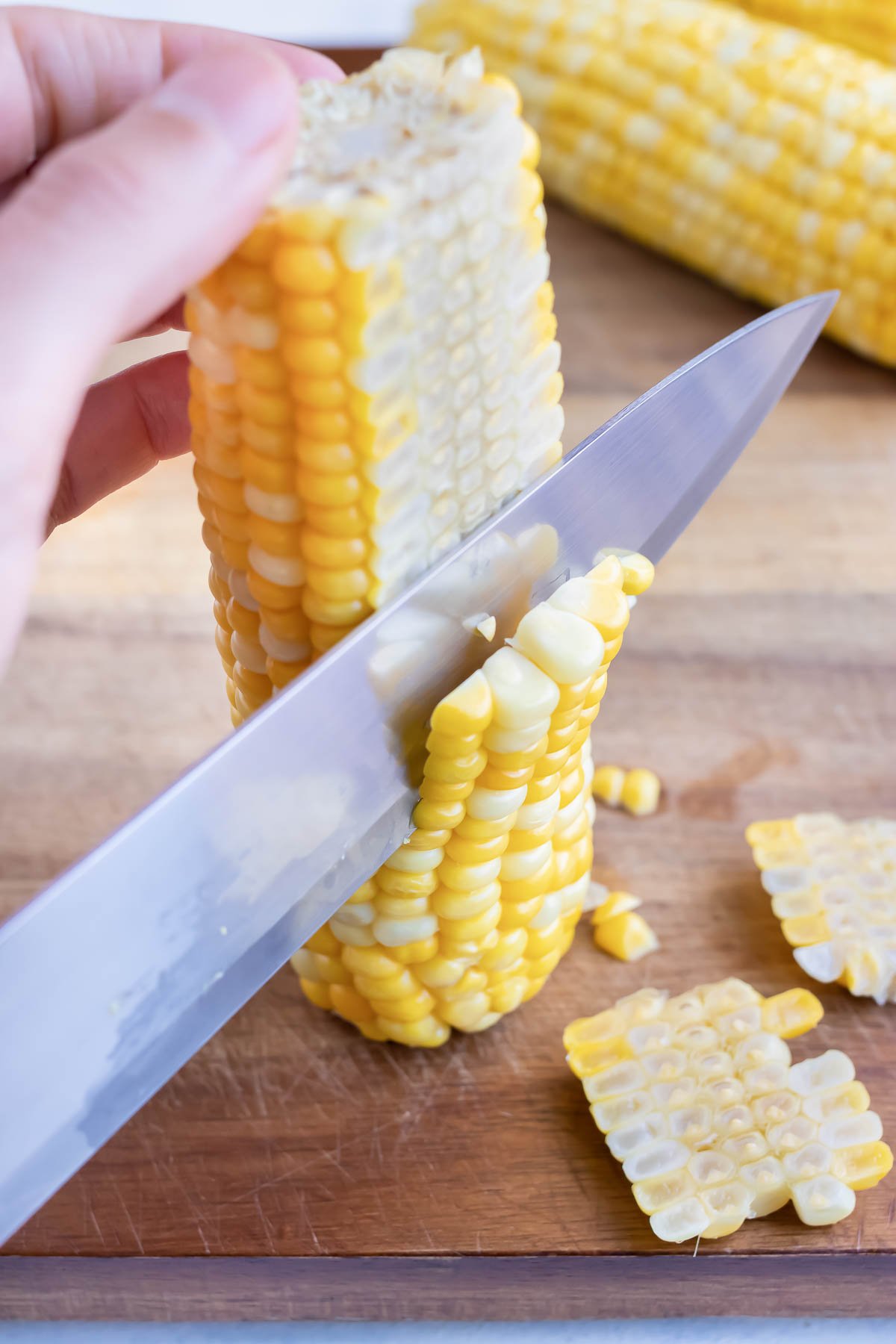 Fresh boiled corn is cut from the cob.
