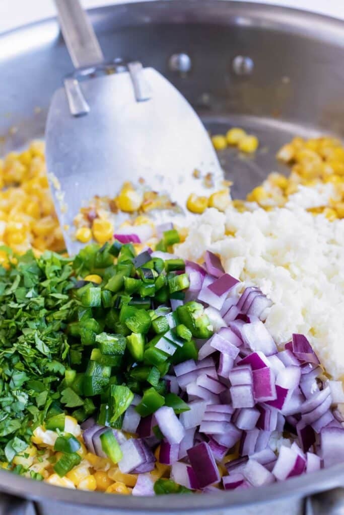 Cilantro, onions, and cheese are added.