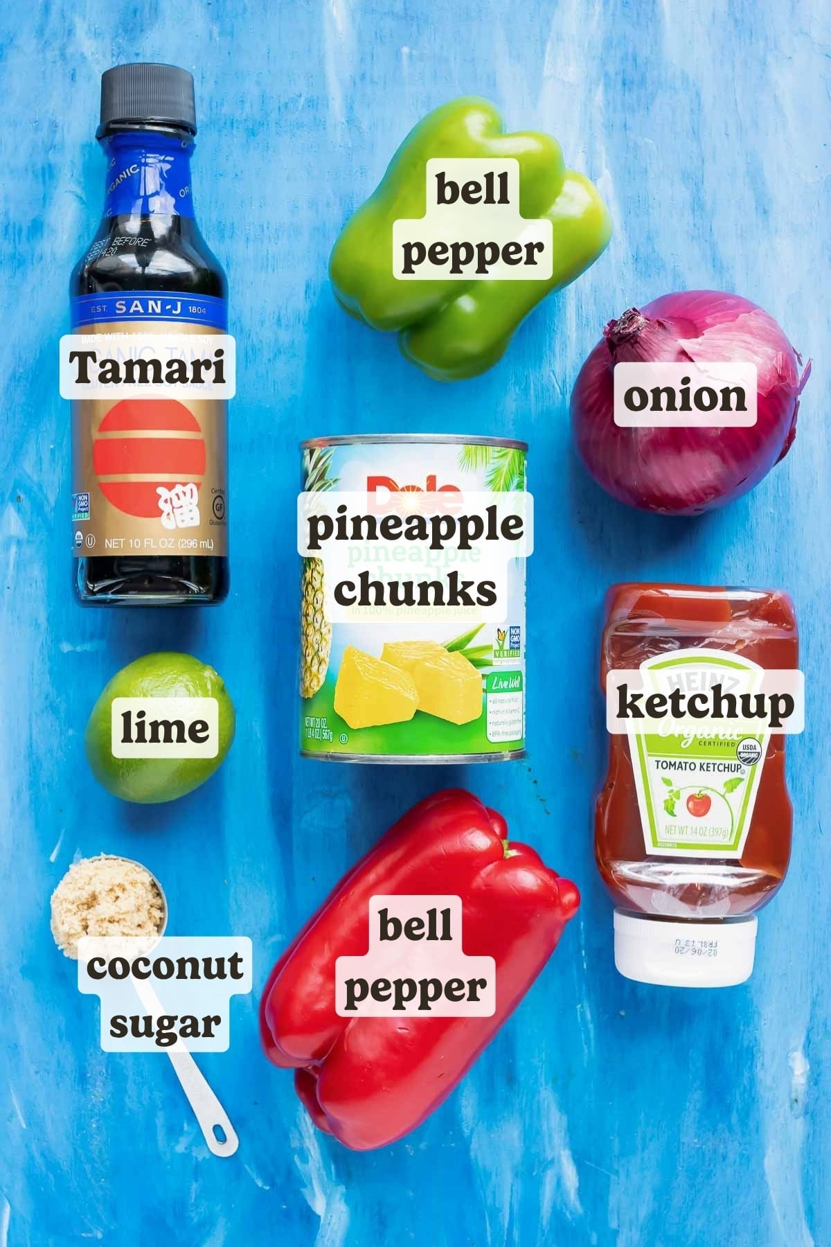 Soy sauce, canned pineapple, bell pepper, onion, ketchup, sugar, and a lime as the ingredients for a pineapple chicken recipe.