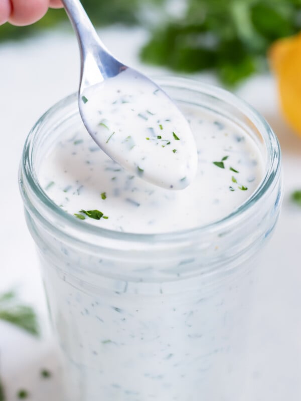 Spoon is used to serve ranch dressing.