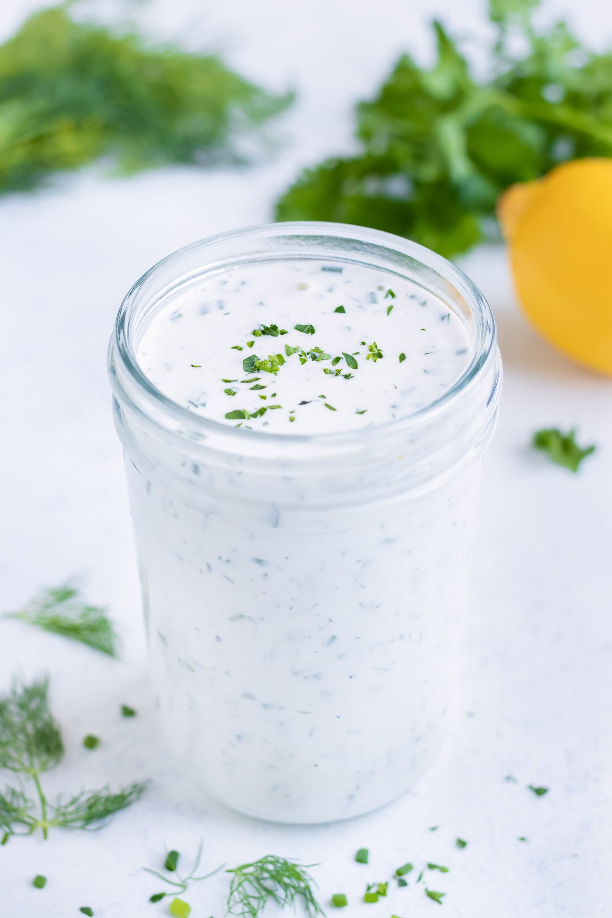 Easy homemade ranch dressing is stored in a glass jar.