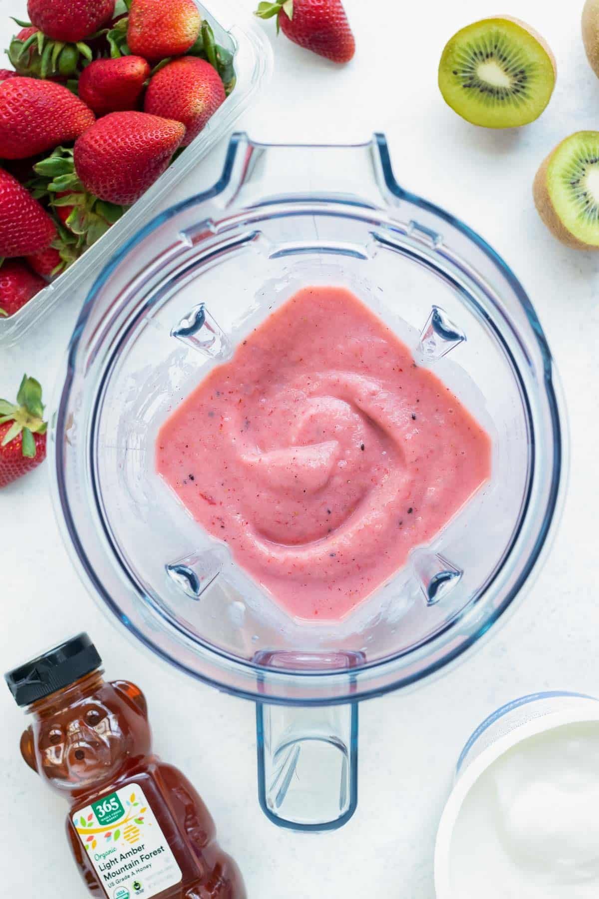 A fruit smoothie recipe made with fresh and frozen fruit, yogurt, and milk are blended together in a Vitamix.