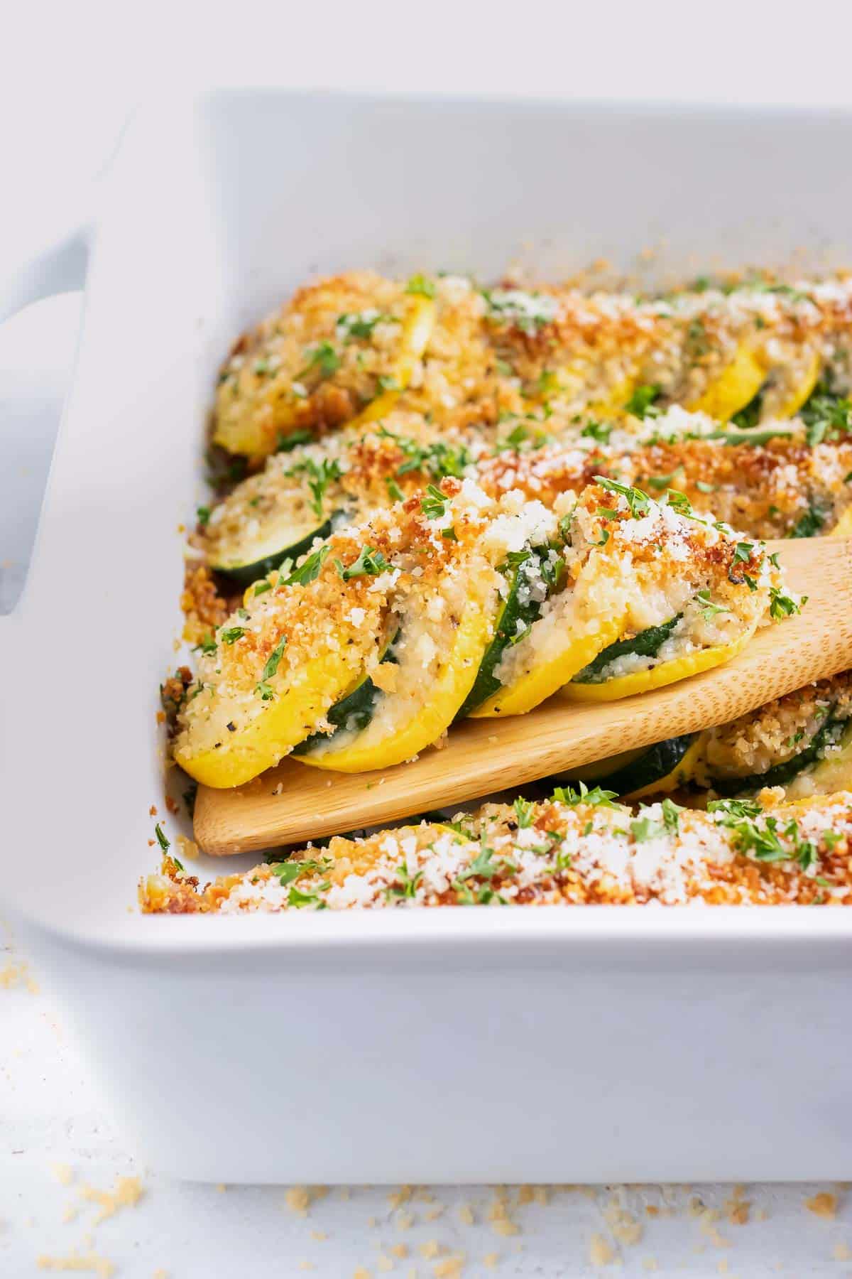 A squash casserole recipe with yellow squash and zucchini and a breadcrumb and Parmesan cheese topping.