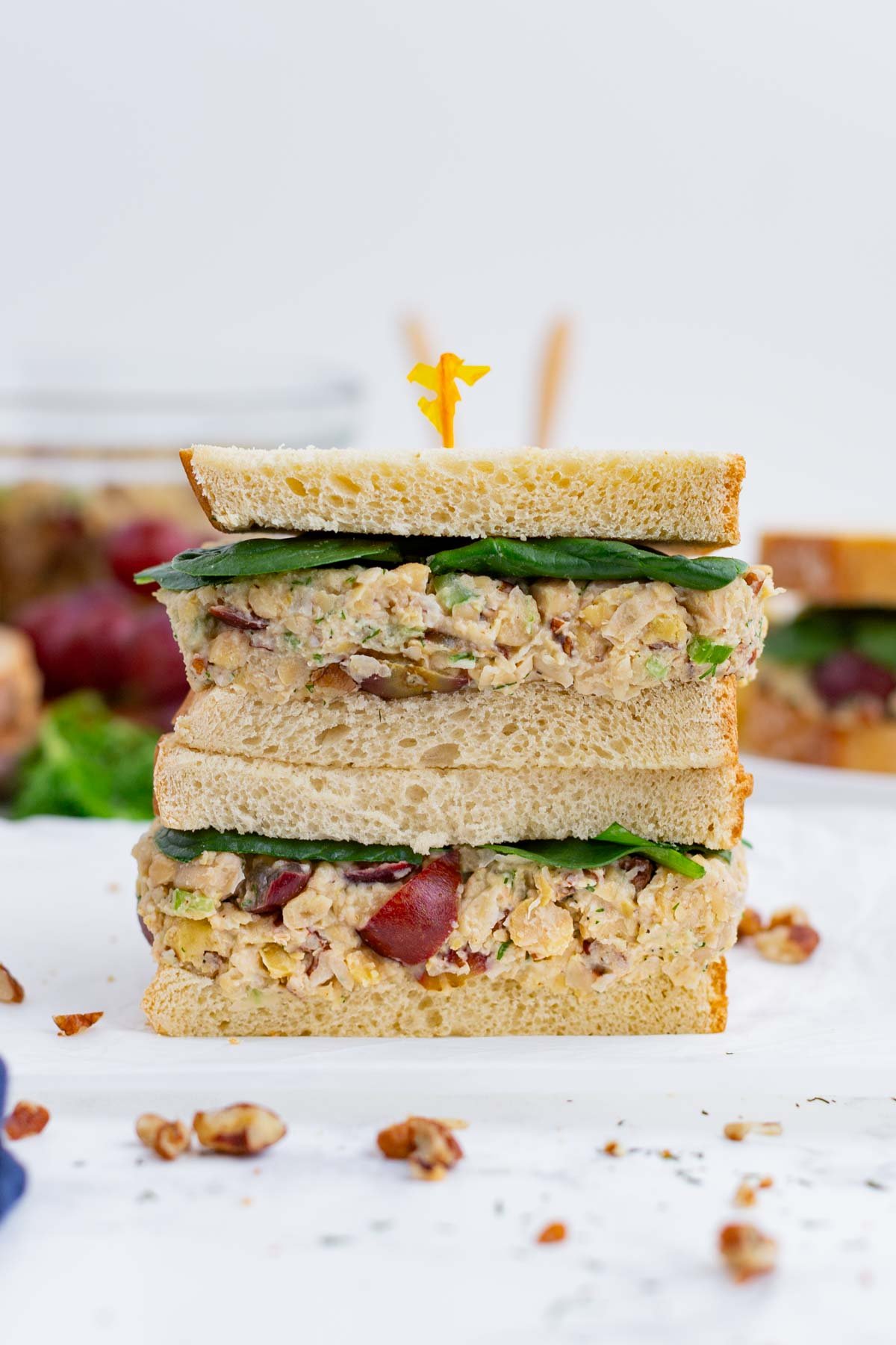 Two halves of a chickpea salad sandwich are stacked on top of each other.