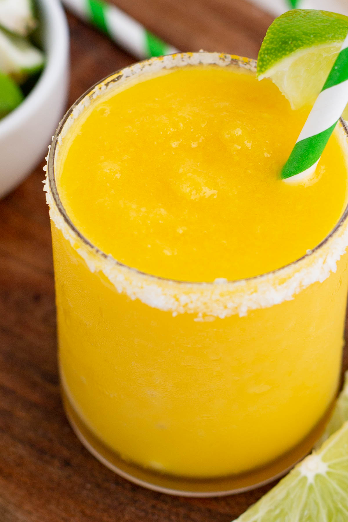 A frozen margarita contains tequila and triple sec with mango.