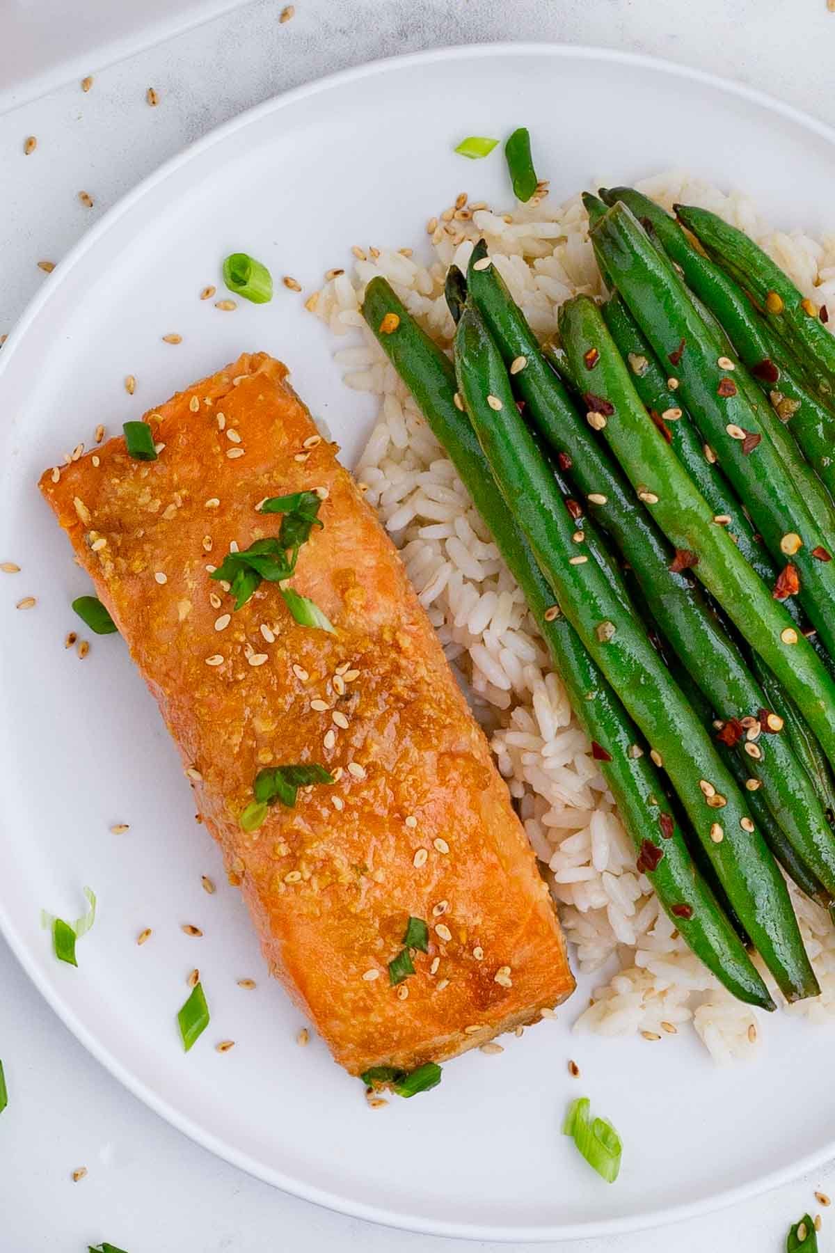Salmon, green beans, and brown rice is a healthy meal.