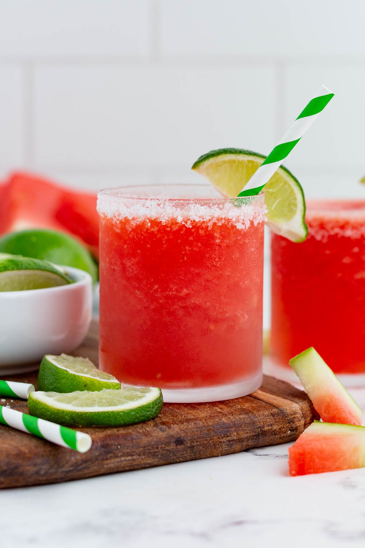 Two glasses of watermelon margarita are ready to drink.