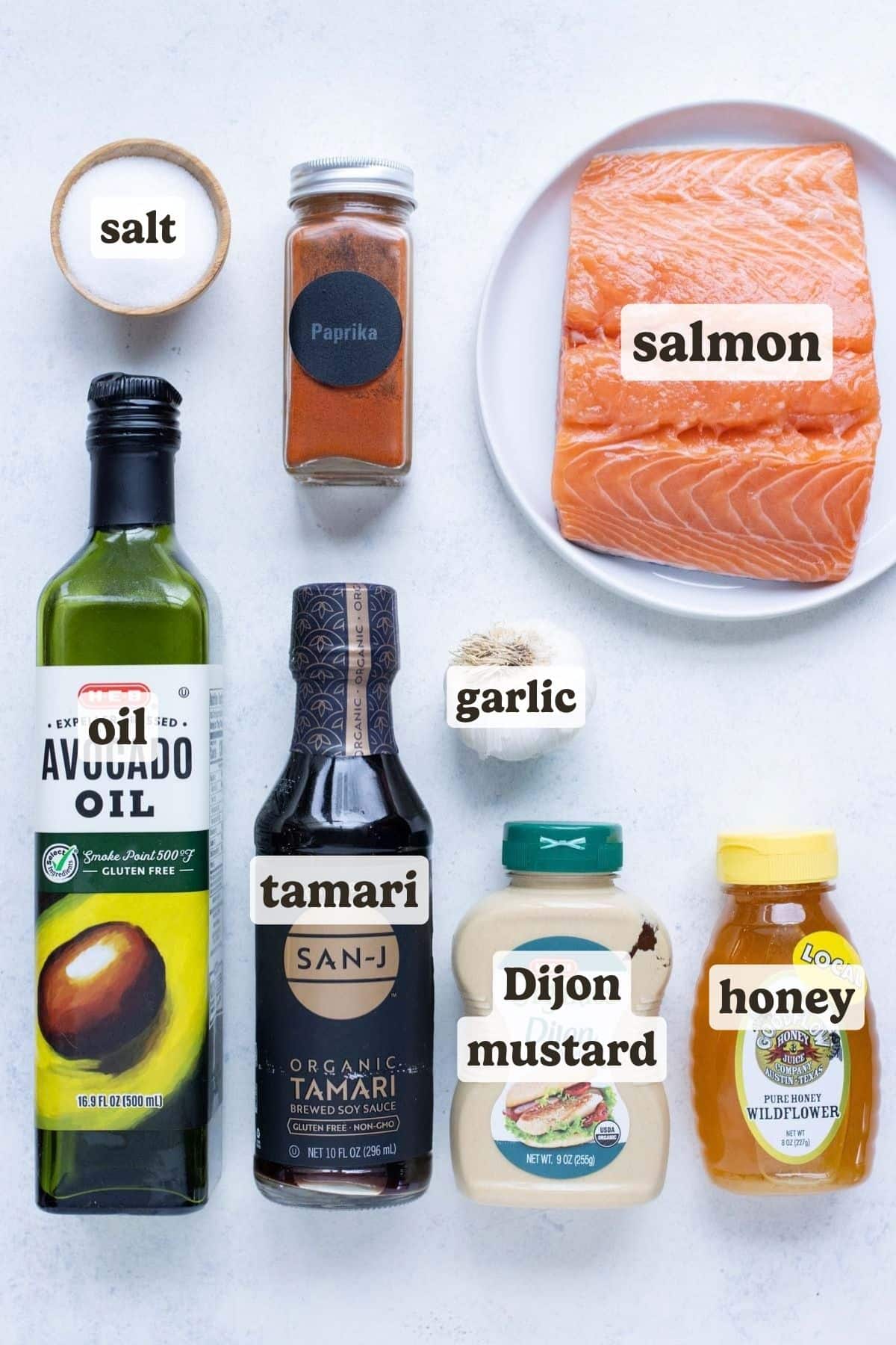 Salmon, honey, avocado oil, garlic, soy sauce, paprika, and dijon mustard are the ingredients for this recipe.