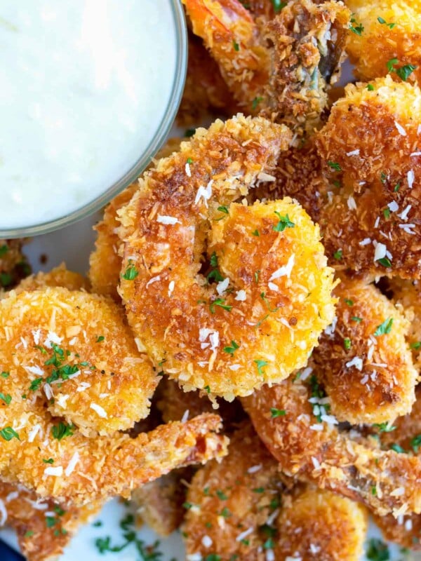 Lightly fried coconut shrimp next to a pineapple dipping sauce.