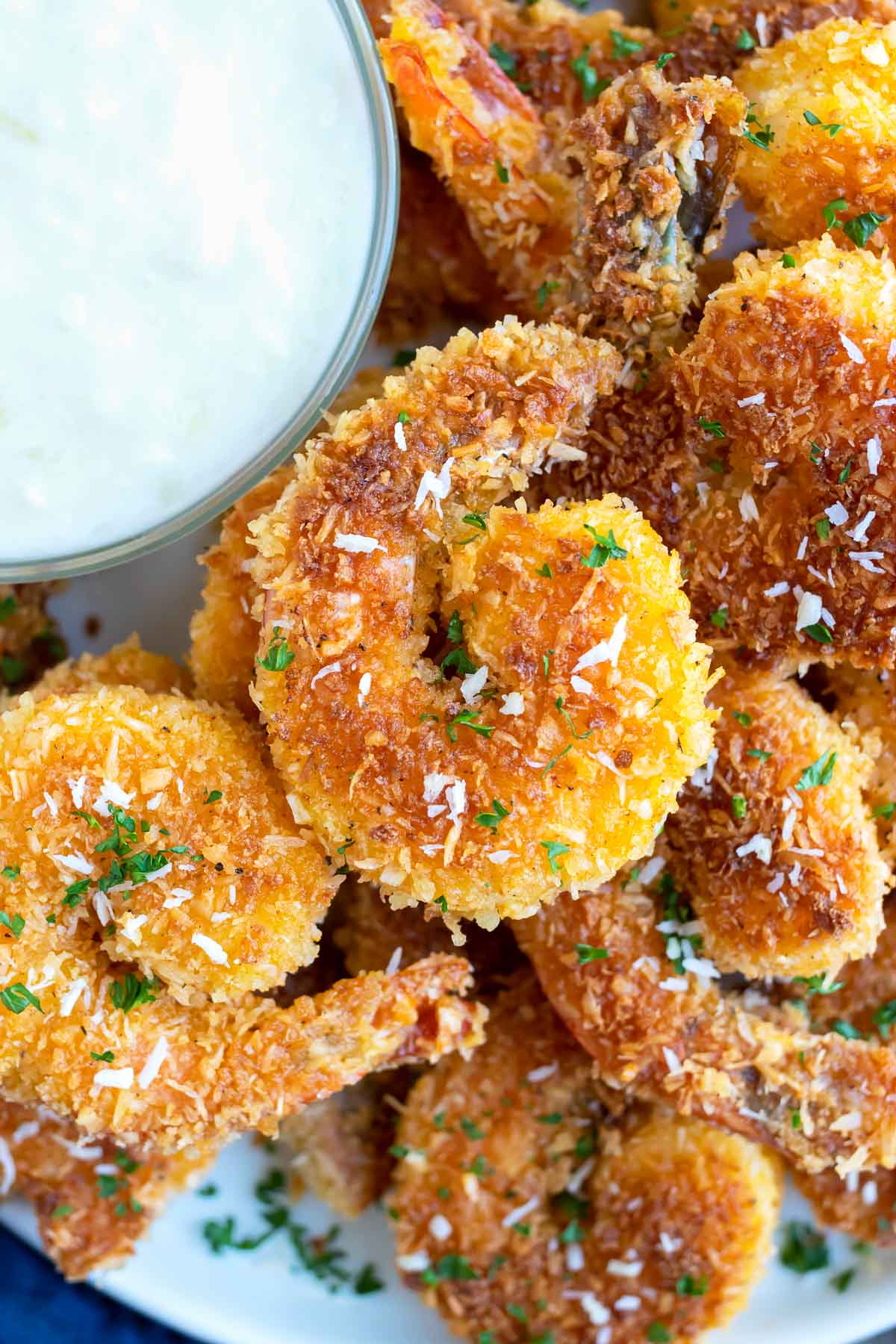 Red Lobster Coconut Fried Shrimp RECIPE served on a white plate with dipping sauce on the side.