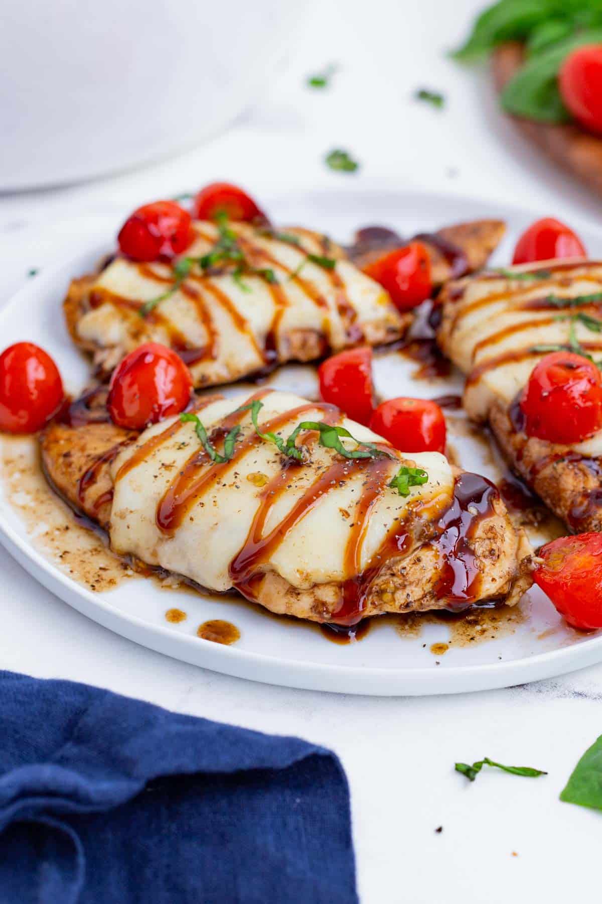 A plate full of perfectly cooked caprese chicken is a quick weeknight dinner.