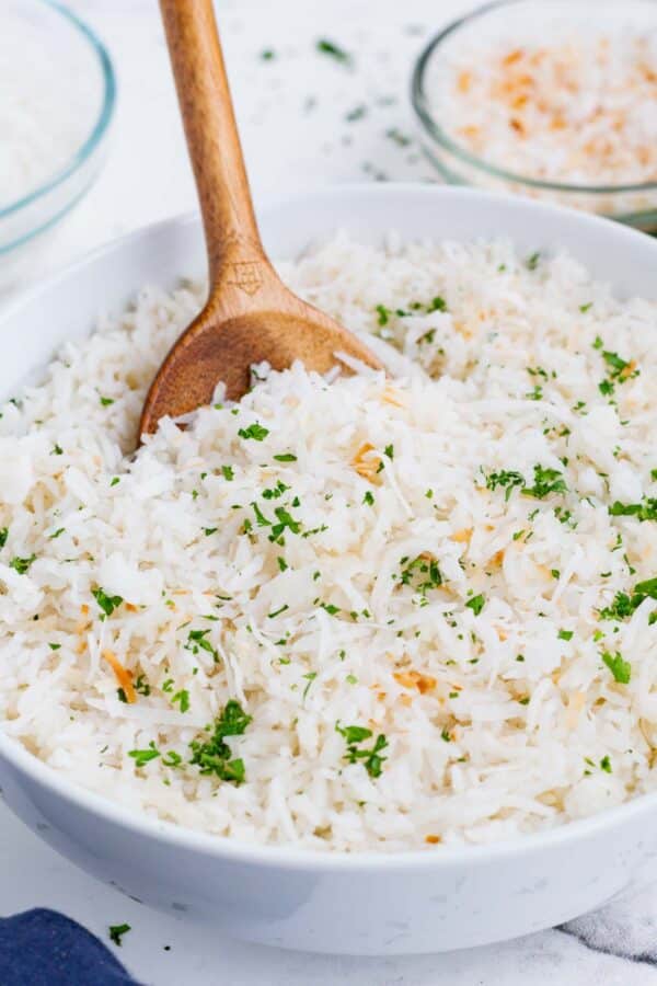 Simply cook rice in coconut milk then top with toasted coconut and basil for a delicious side.