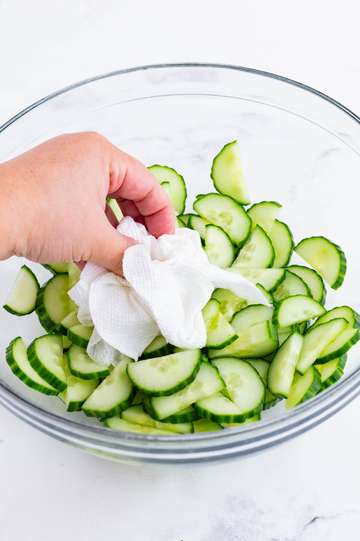 A paper towel dries excess moisture on cucumbers.