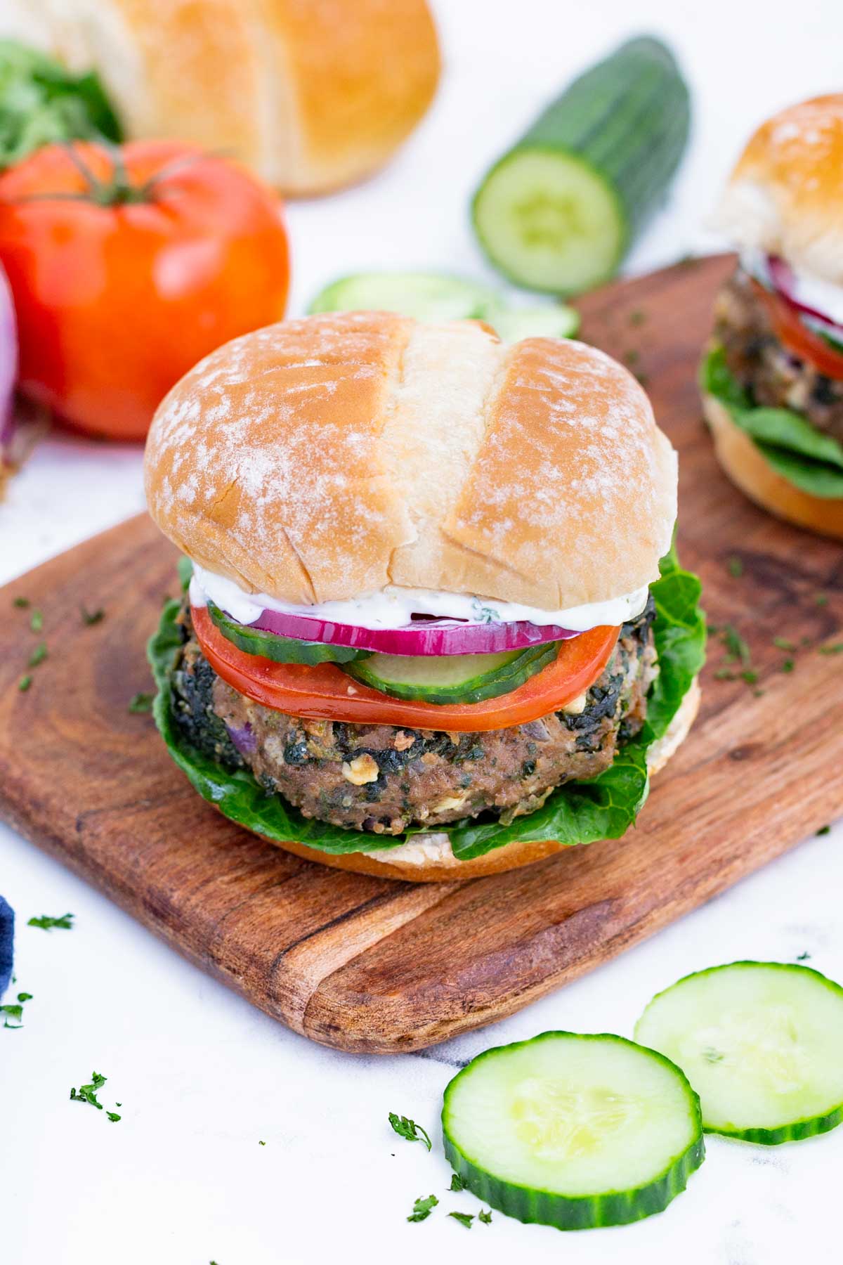 Top this Greek burger with tzatziki sauce, cucumber, and tomatoes.