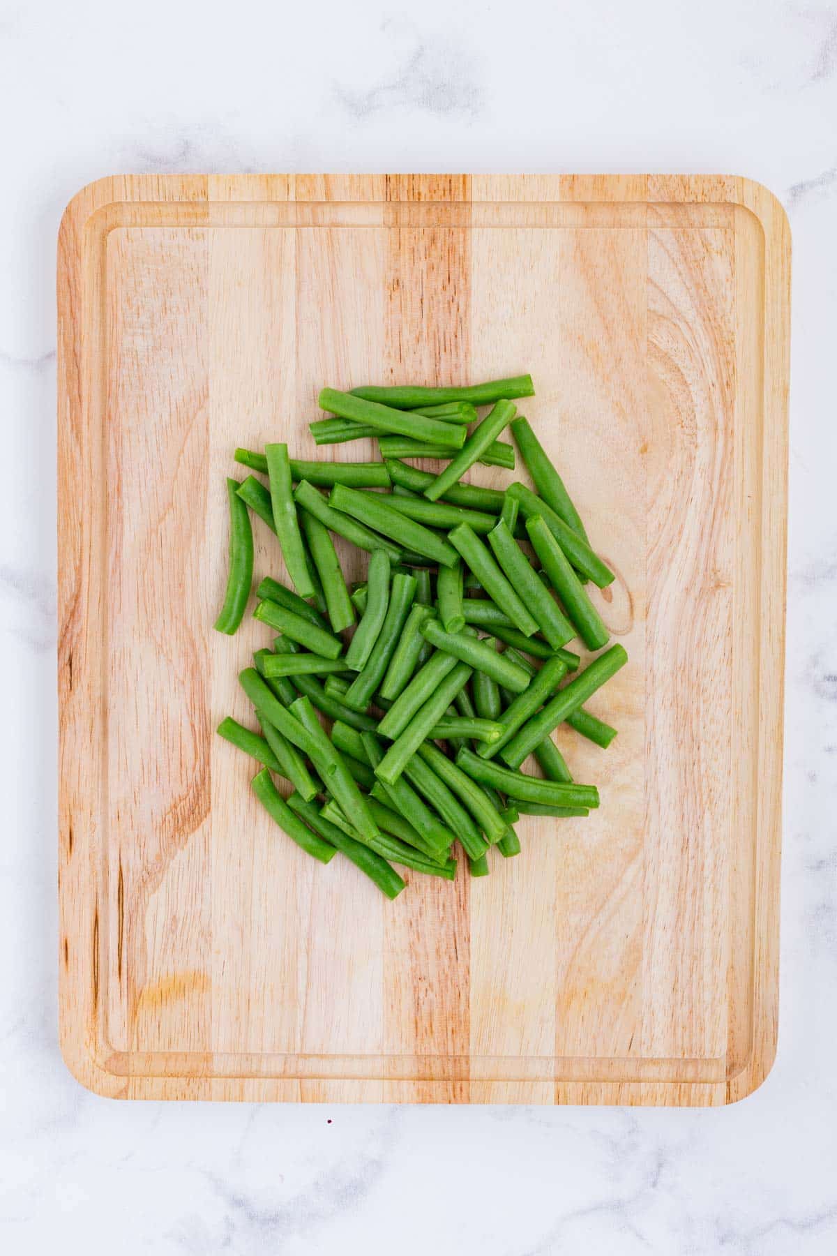 Green beans are trimmed and cut.