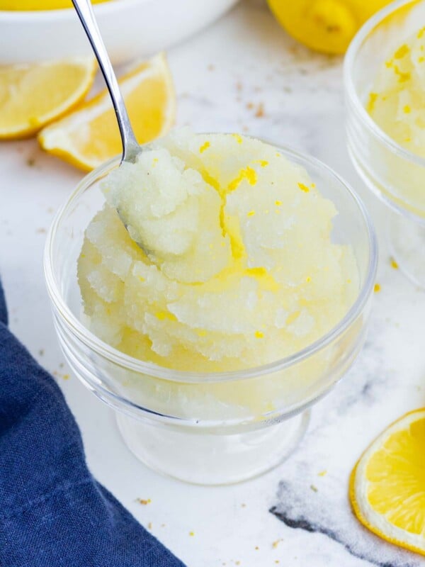 A spoon scoops out a bite of lemon sorbet.