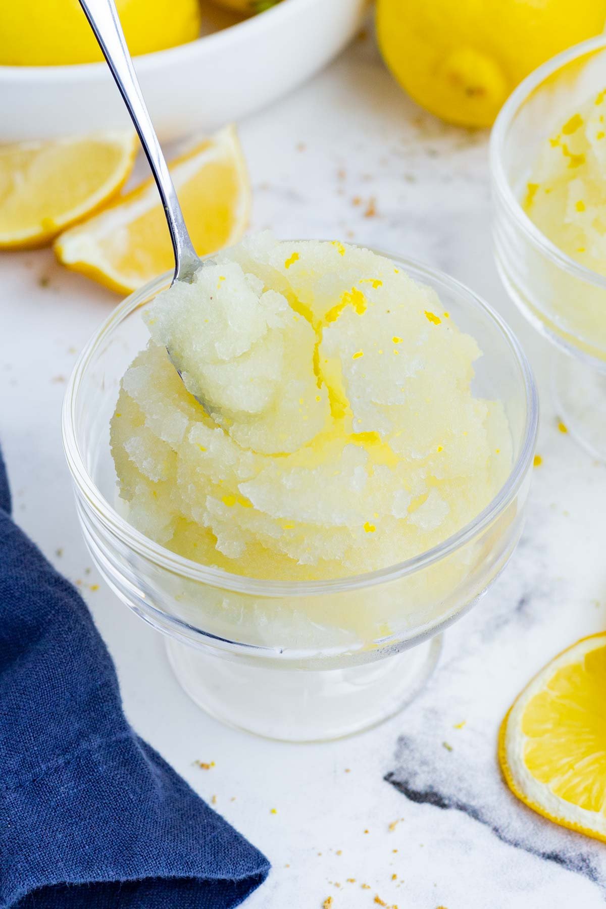 A spoon scoops out a bite of lemon sorbet.