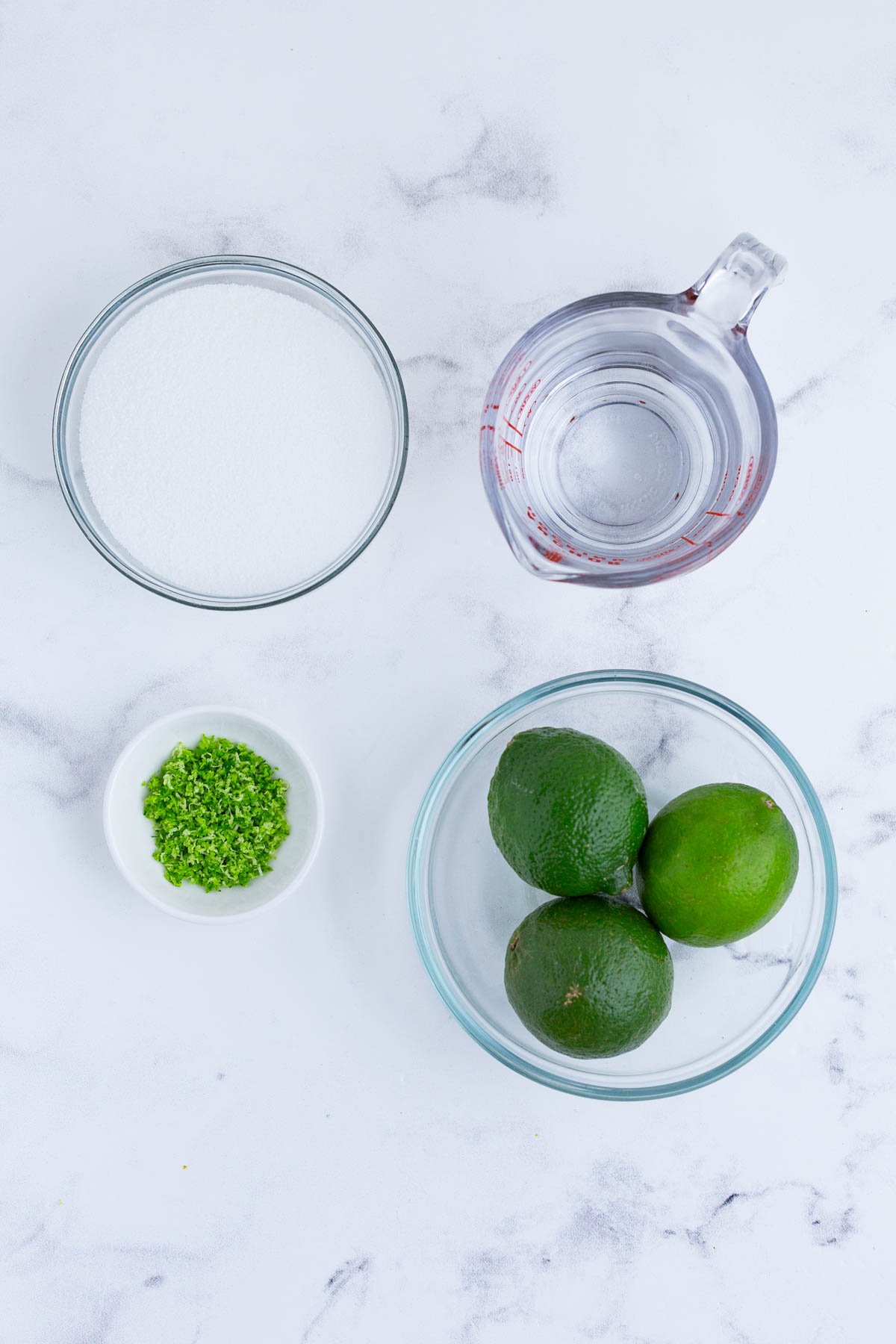 Limes, water, and sugar are the ingredients for this recipe.