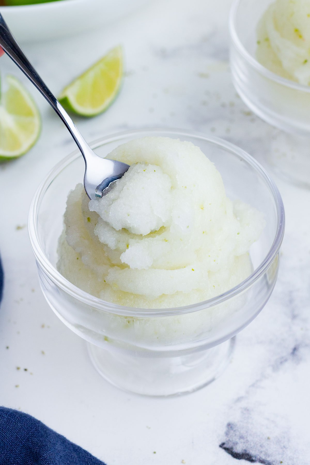 Lime sorbet is served in a glass cup.