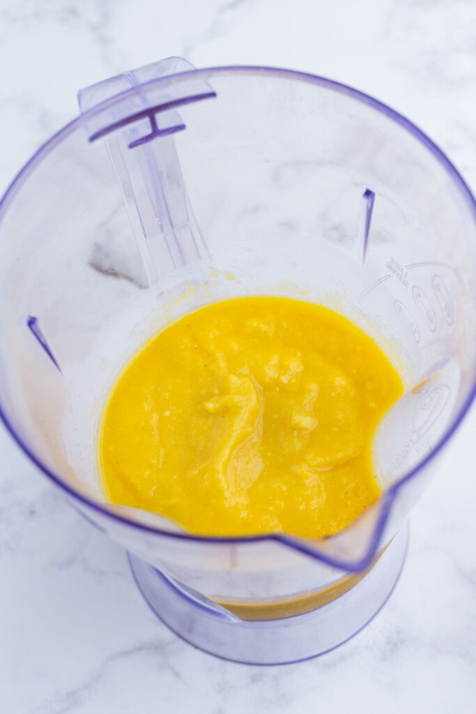 The mango sorbet ingredients are blended.