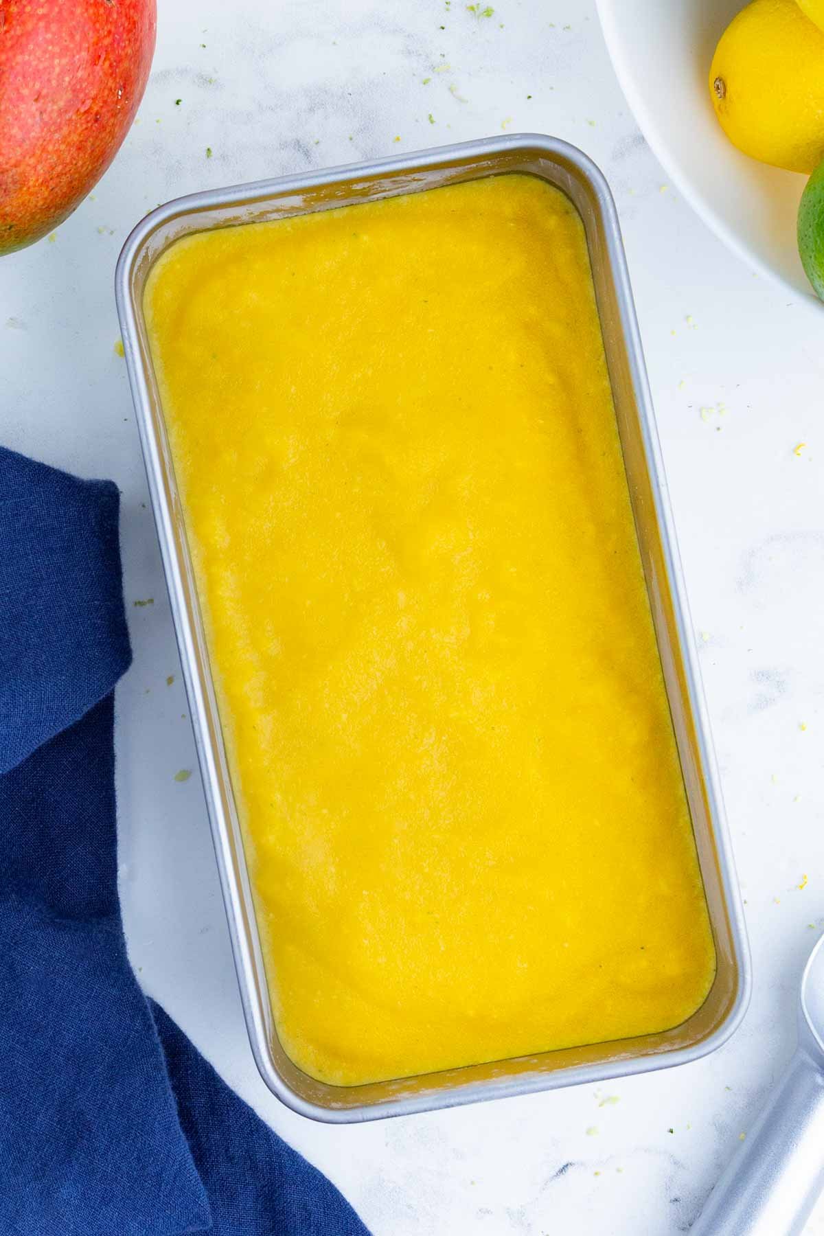 Blended sorbet is poured into a loaf pan to freeze.